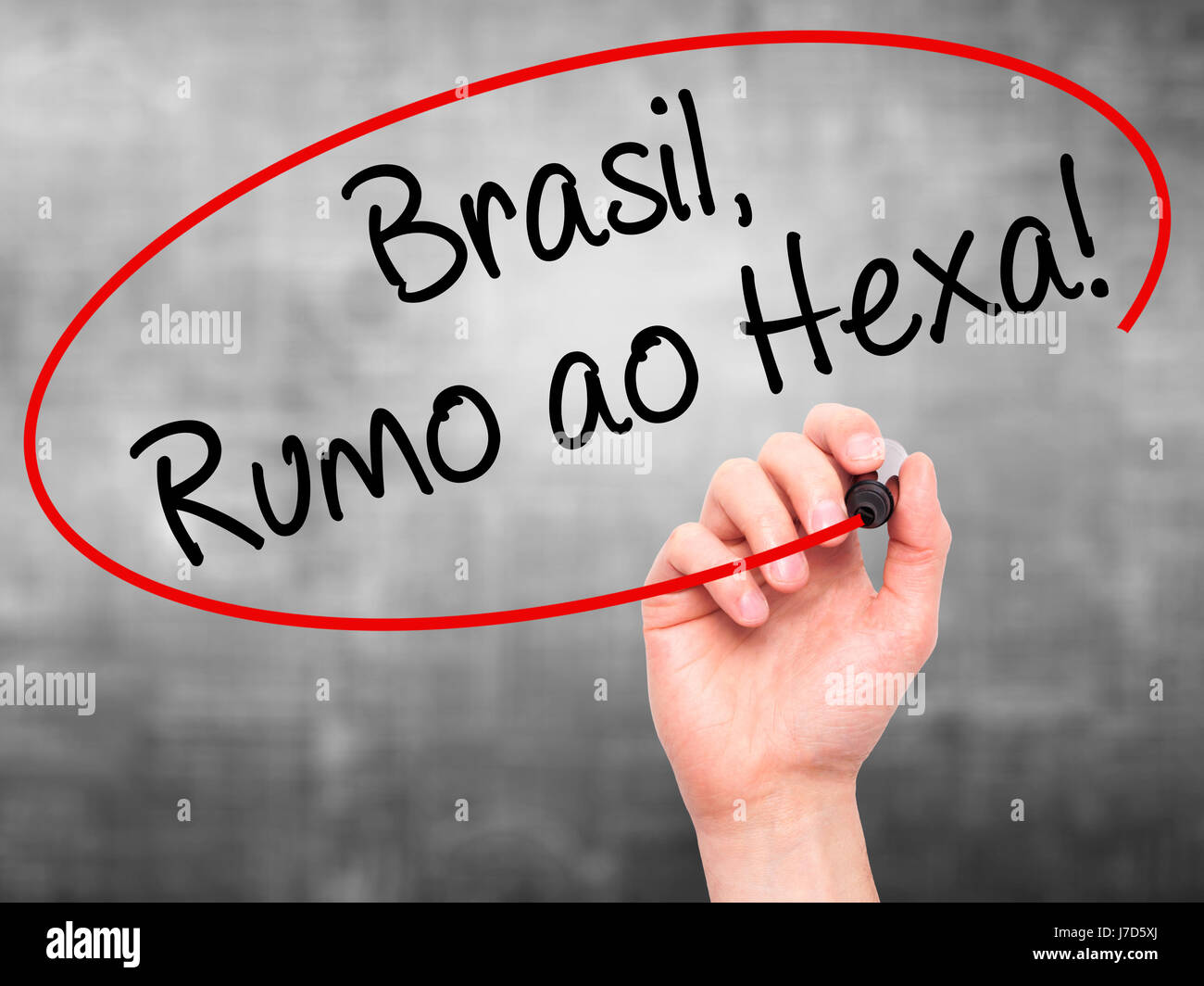 Man Hand writing Brasil, Rumo ao Hexa! with black marker on visual screen. Isolated on background. Business, technology, internet concept. Stock Photo Stock Photo
