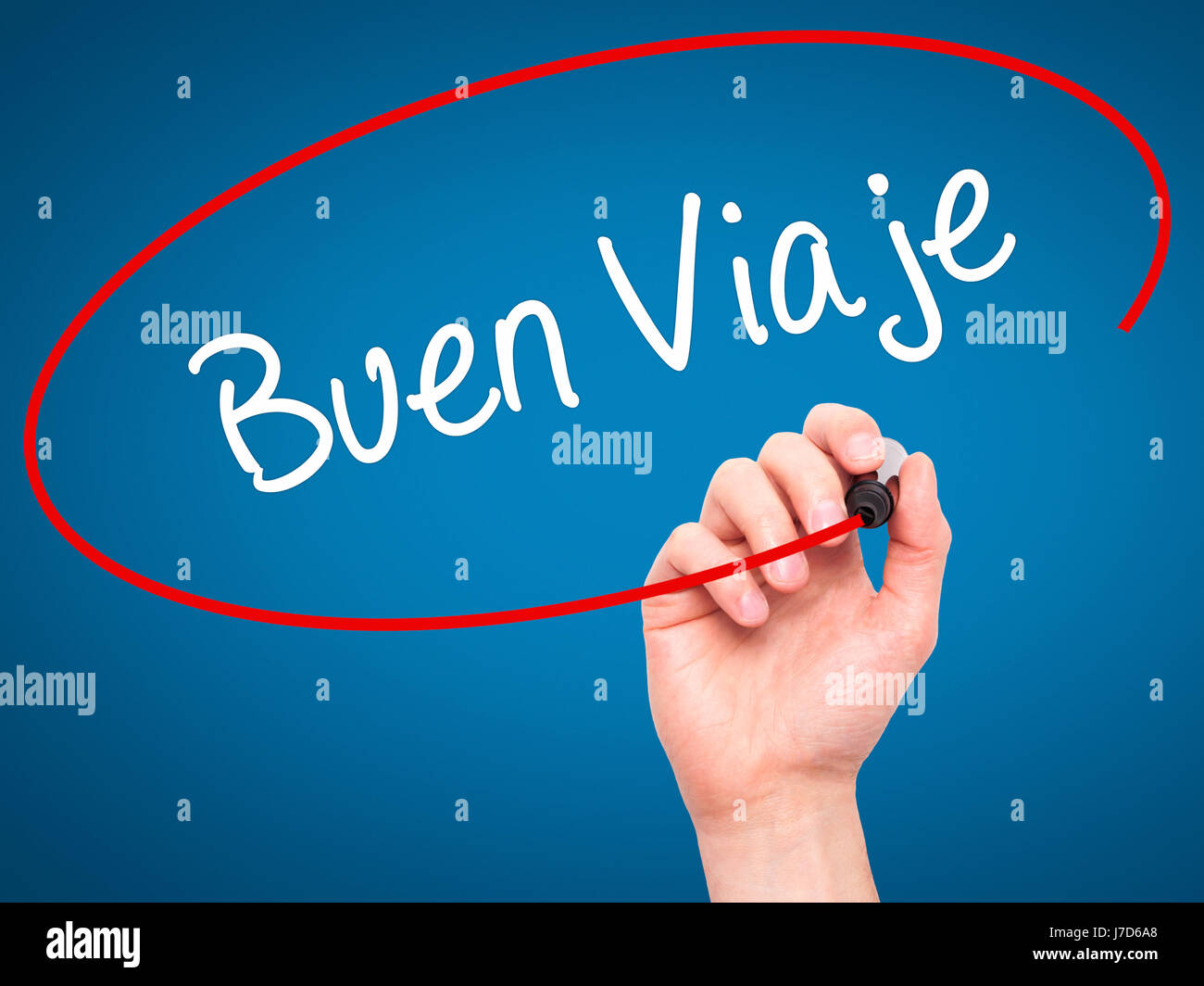 Man Hand writing Buen Viaje (Good Trip in Spanish) with black marker on visual screen. Isolated on blue. Business, technology, internet concept. Stock Stock Photo