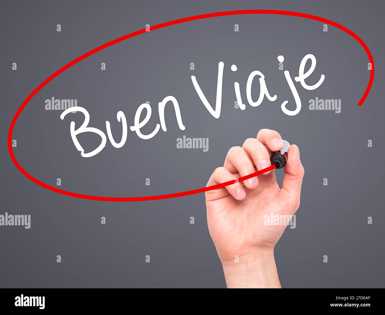 Man Hand writing Buen Viaje (Good Trip in Spanish) with black marker on visual screen. Isolated on grey. Business, technology, internet concept. Stock Stock Photo