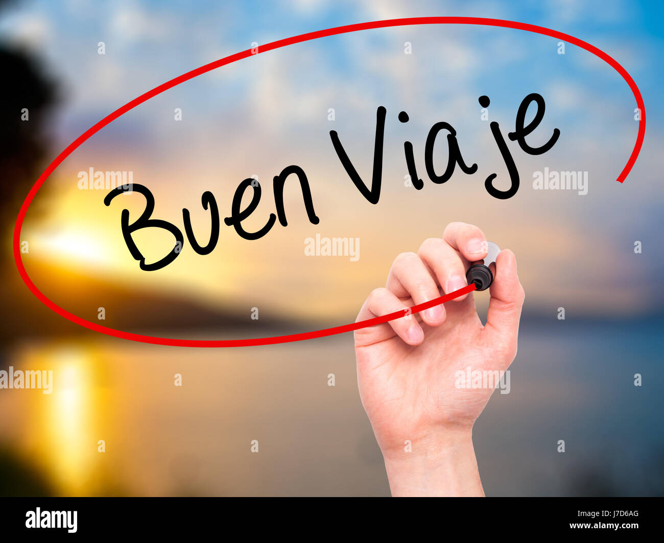 Man Hand writing Buen Viaje (Good Trip in Spanish) with black marker on visual screen. Isolated on nature. Business, technology, internet concept. Sto Stock Photo