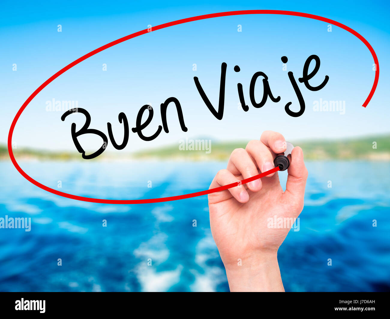 Man Hand writing Buen Viaje (Good Trip in Spanish) with black marker on visual screen. Isolated on nature. Business, technology, internet concept. Sto Stock Photo