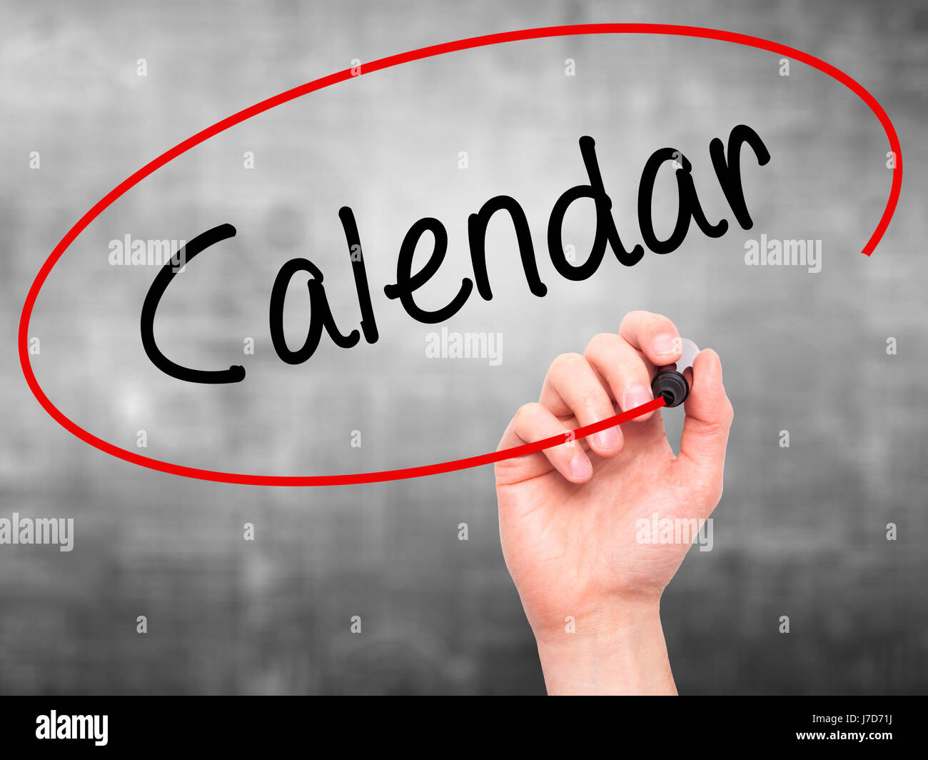 Man Hand writing Calendar   with black marker on visual screen. Isolated on grey. Business, technology, internet concept. Stock Photo