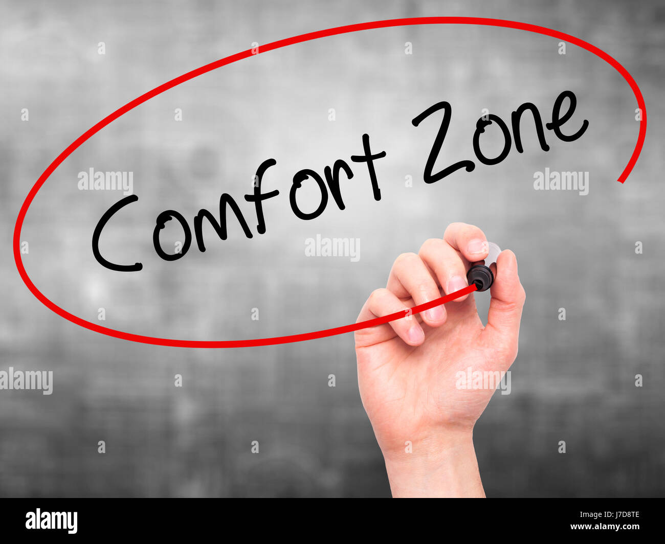 Man Hand writing Comfort Zone with black marker on visual screen