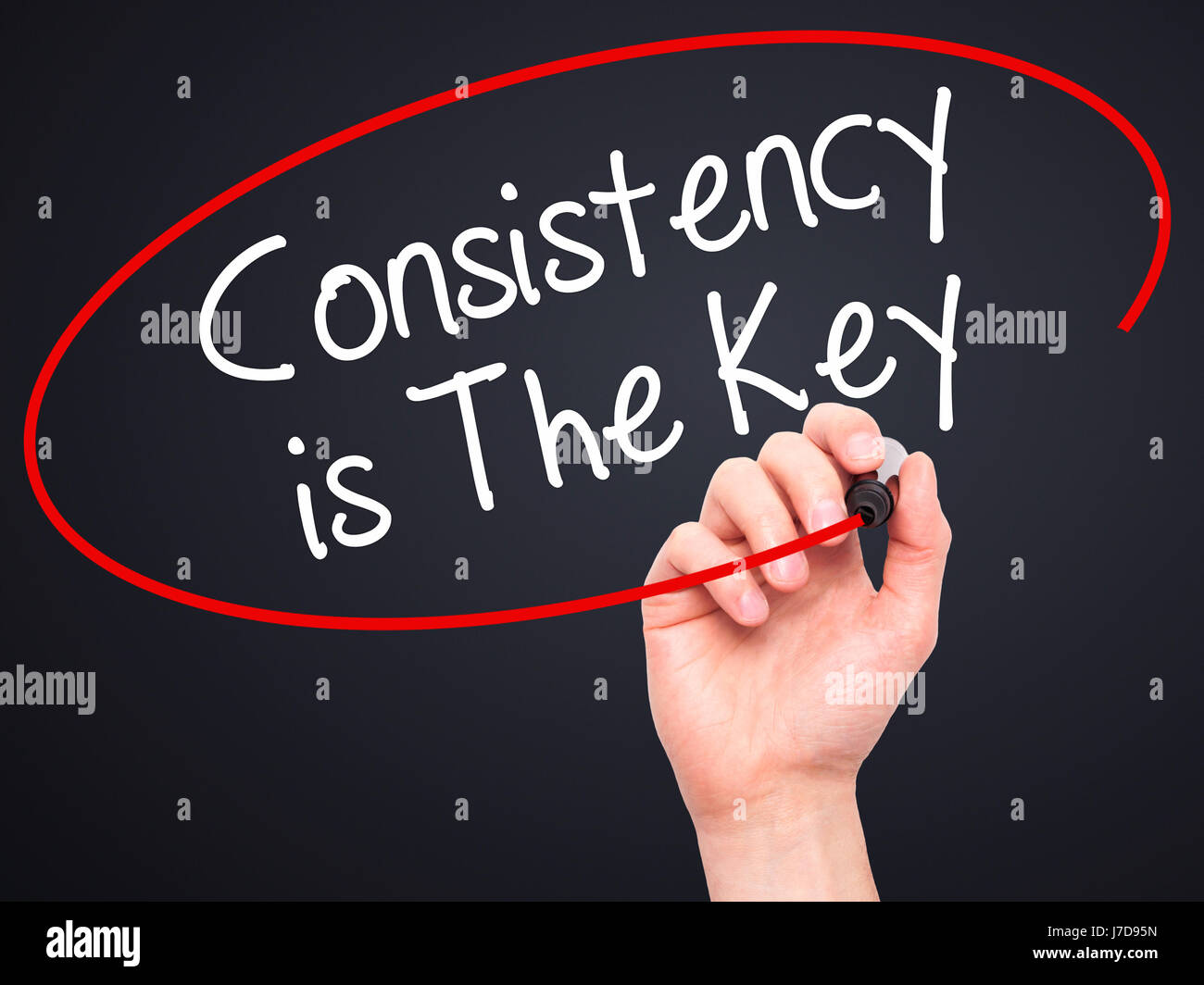 Man Hand writing Consistency is The Key with black marker on visual ...