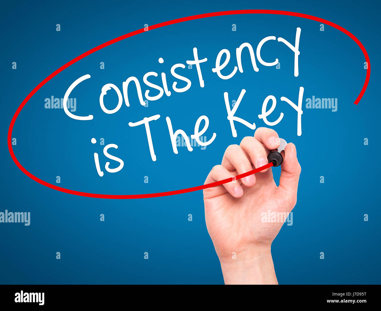 Man Hand writing Consistency is The Key with black marker on visual ...
