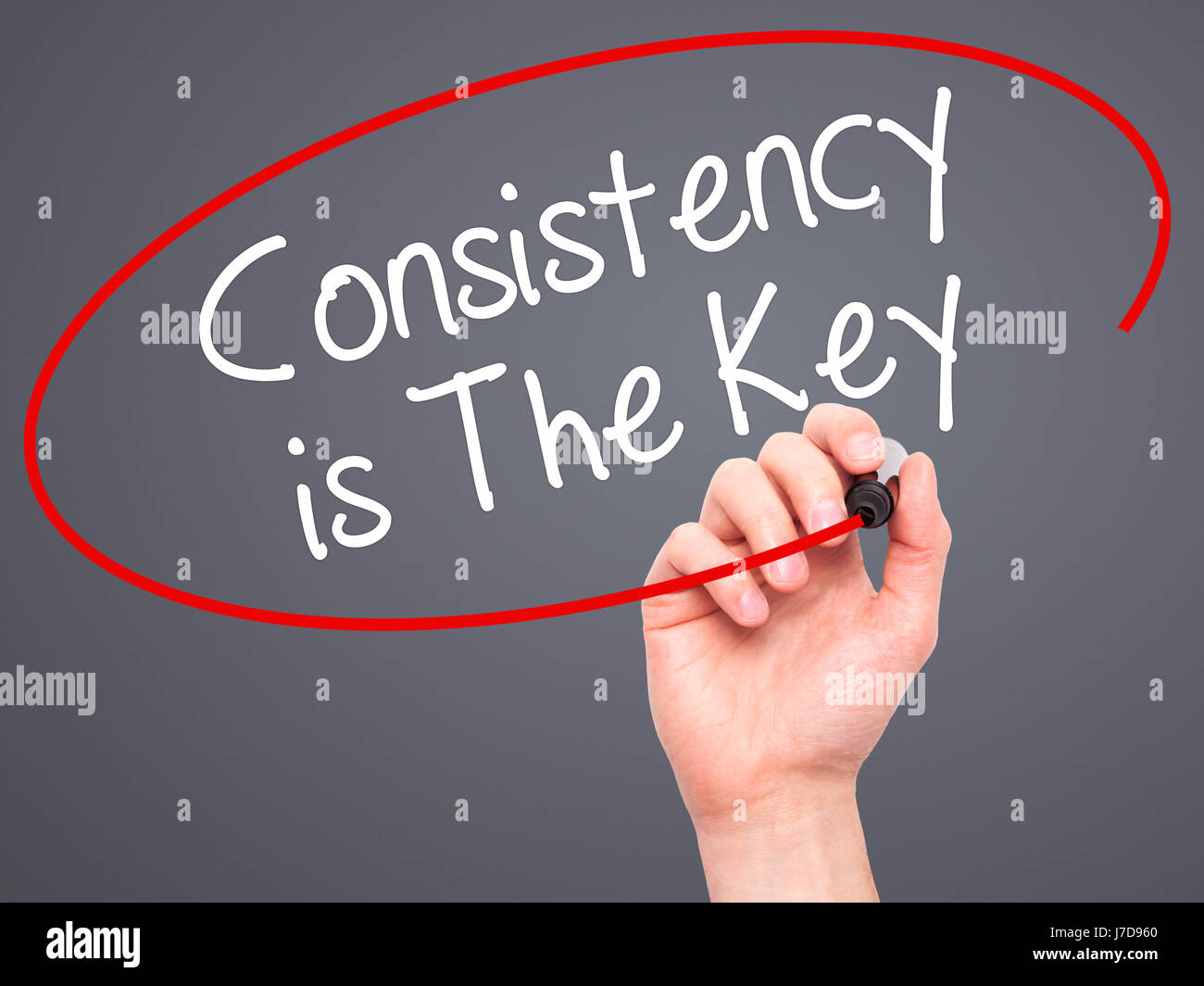 Man Hand writing Consistency is The Key with black marker on visual ...