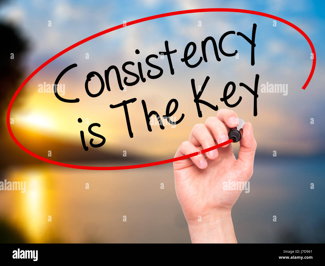 Man Hand writing Consistency is The Key with black marker on visual ...