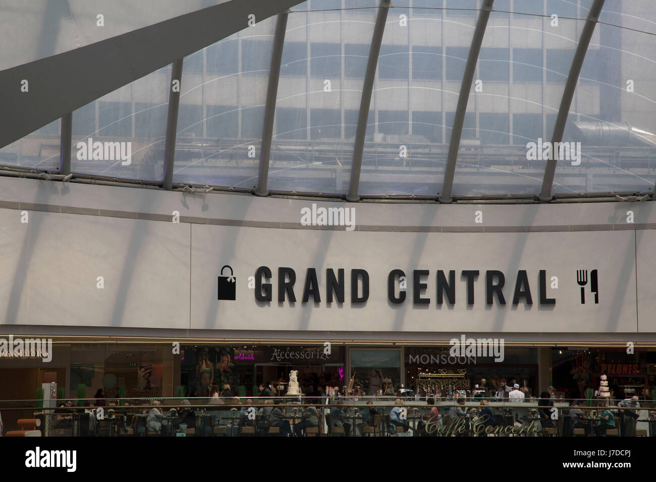 Interior of Grand Central in Birmingham, United Kingdom. Grand Central is a shopping centre located in Birmingham, England, that opened on 24 September 2015. It is currently owned by Hammerson and CPPIB. The original centre was built in 1971 as part of the reconstruction of Birmingham New Street station. It was known as the Birmingham Shopping Centre before being renamed as The Pallasades. As part of the New Street Station Gateway Plus redevelopment, Grand Central underwent a major overhaul. The mall has been redesigned with a glass atrium roof as centrepiece, and is home to over 60 stores wit Stock Photo