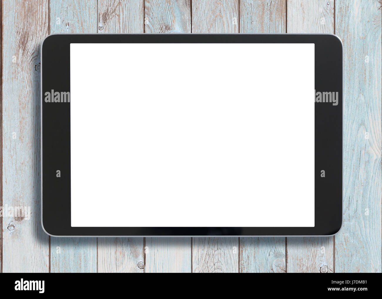 Black tablet pc looking similar to ipad on old white wood background Stock Photo