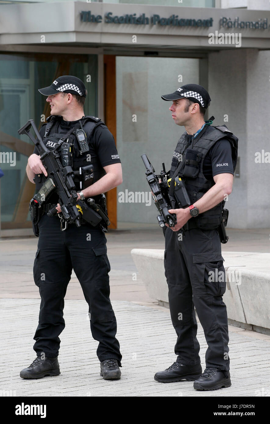 Armed police on patrol outside the Scottish Parliament building in