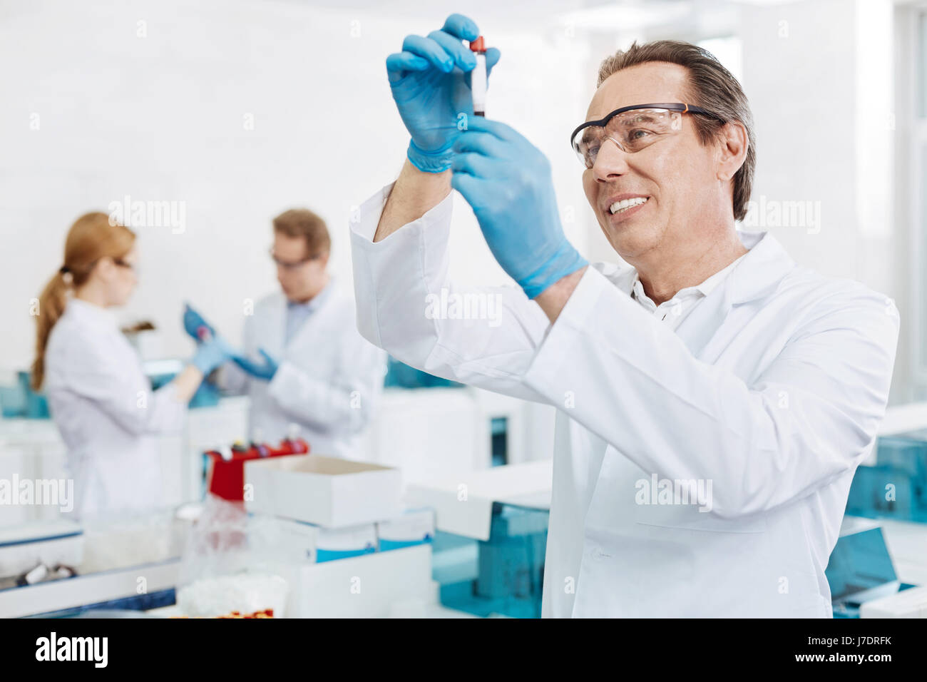 Positive delighted scientist standing in semi position Stock Photo