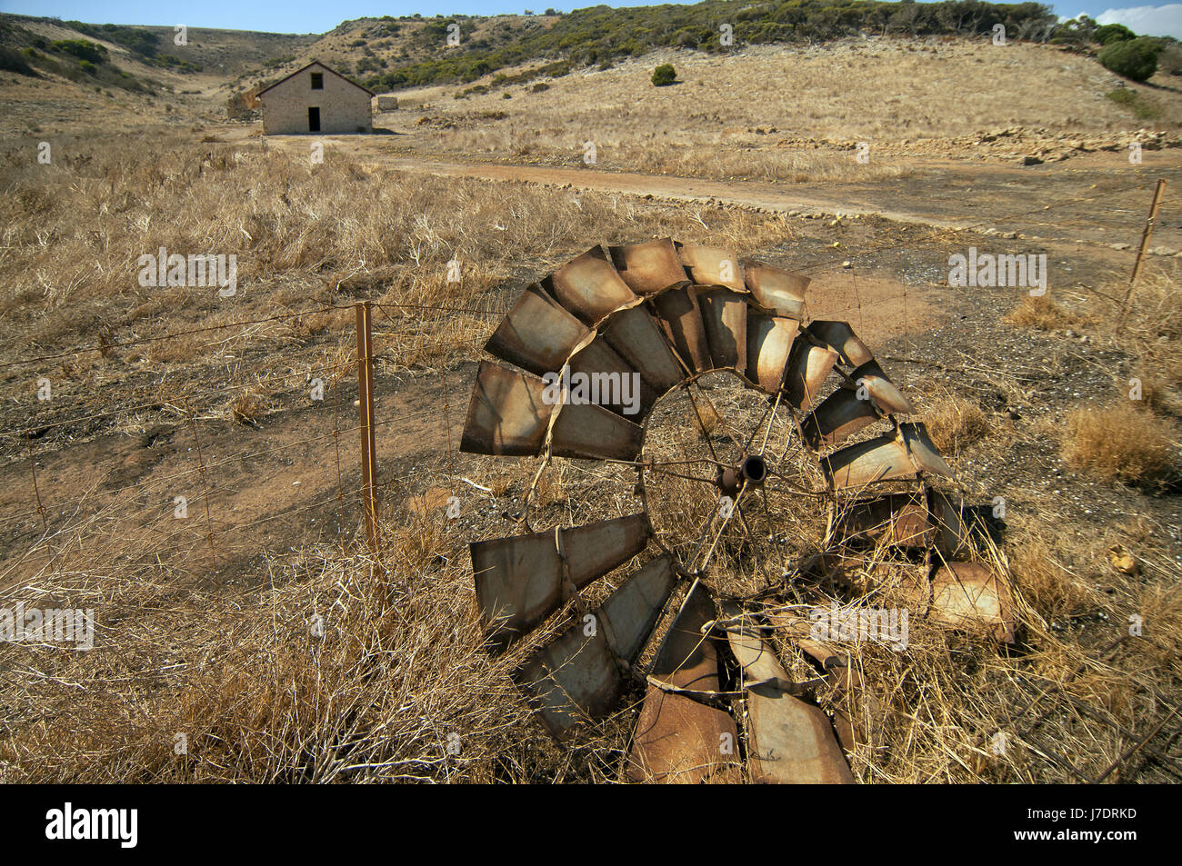 An abandoned Southern Cross windmill lies in the parched grass, in the Kalbarri area of Western Australia. Stock Photo