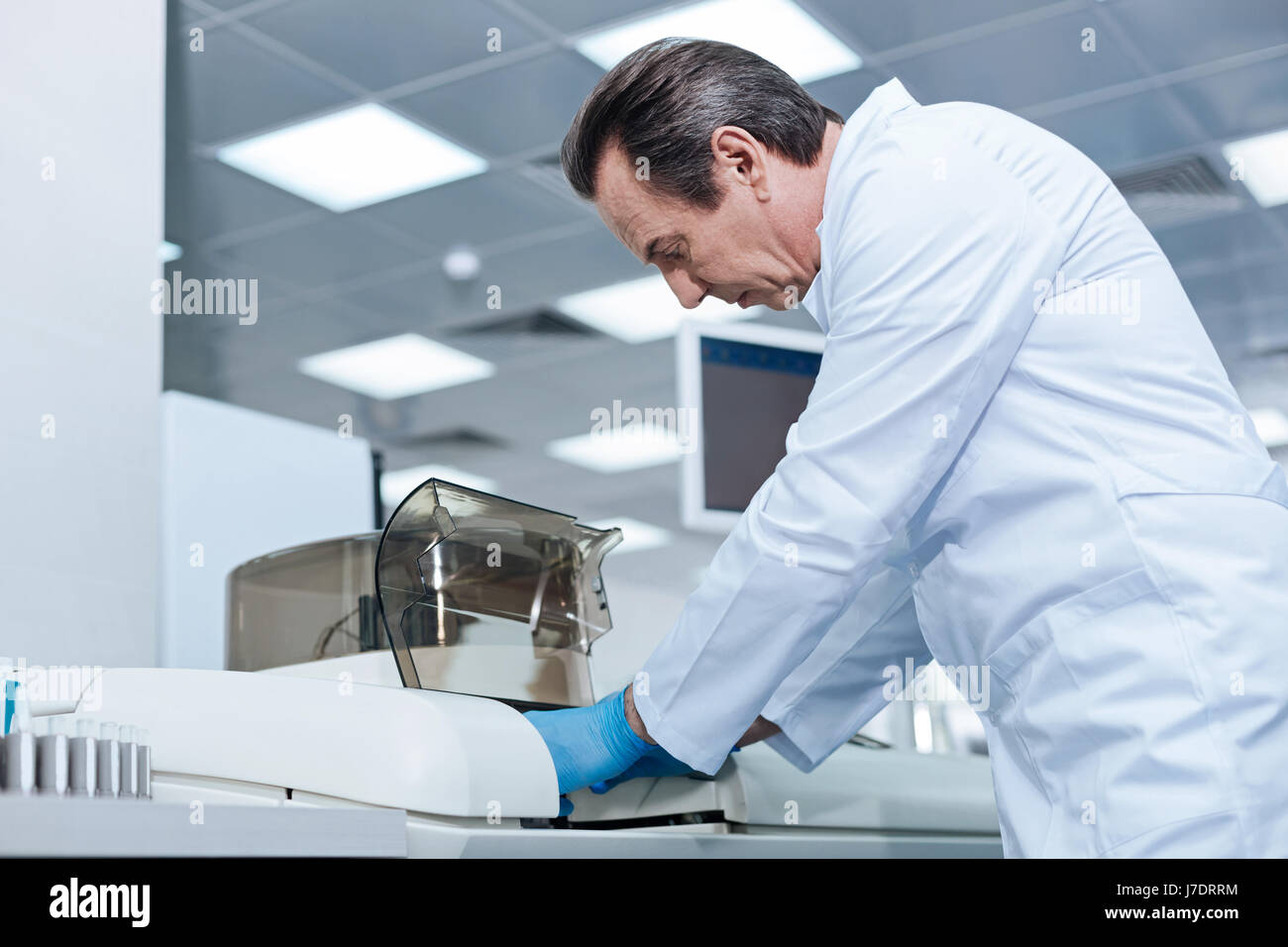 Exhausted gray-haired man bowing his head Stock Photo