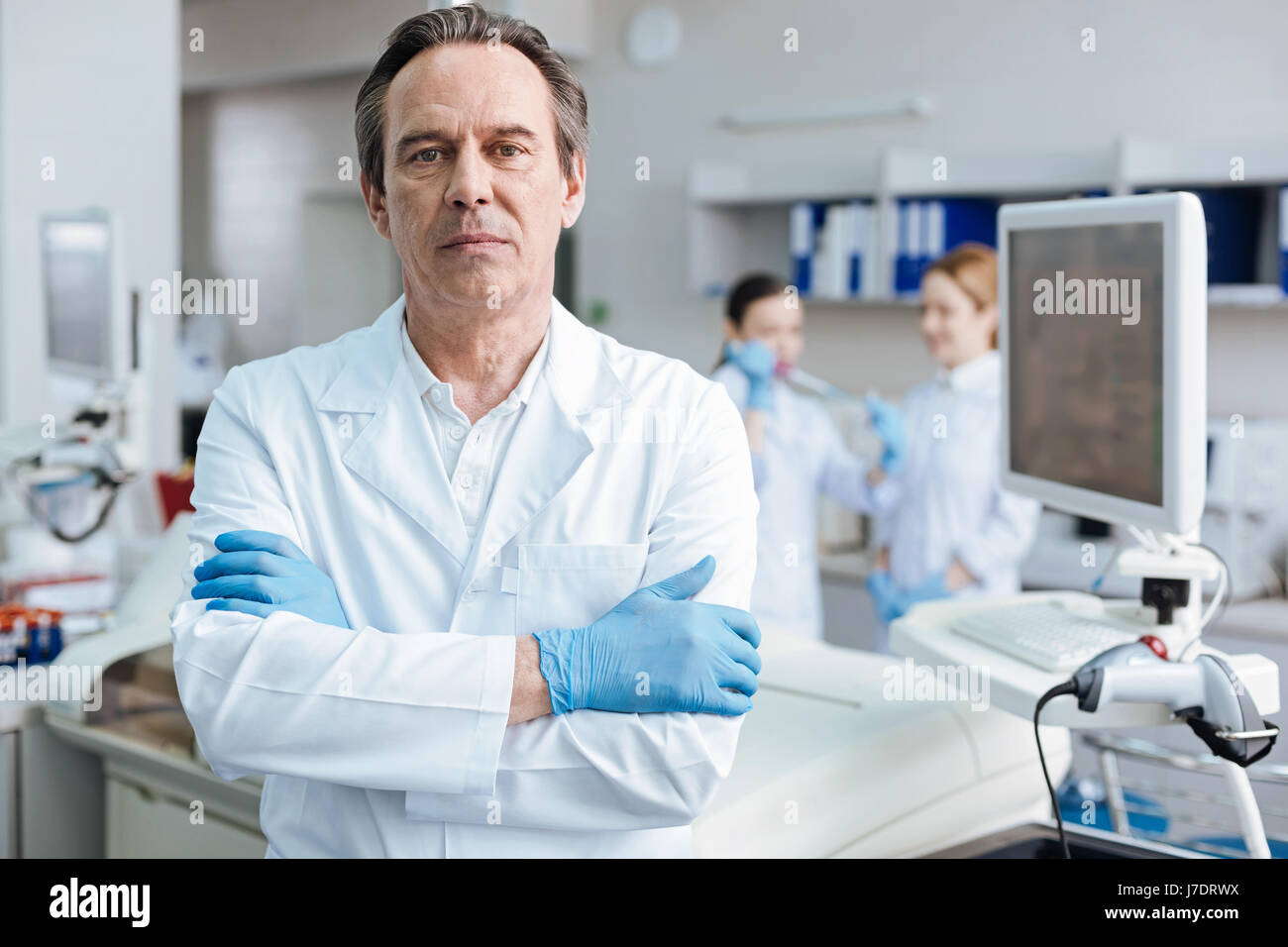 Serious male person crossing arms on chest Stock Photo