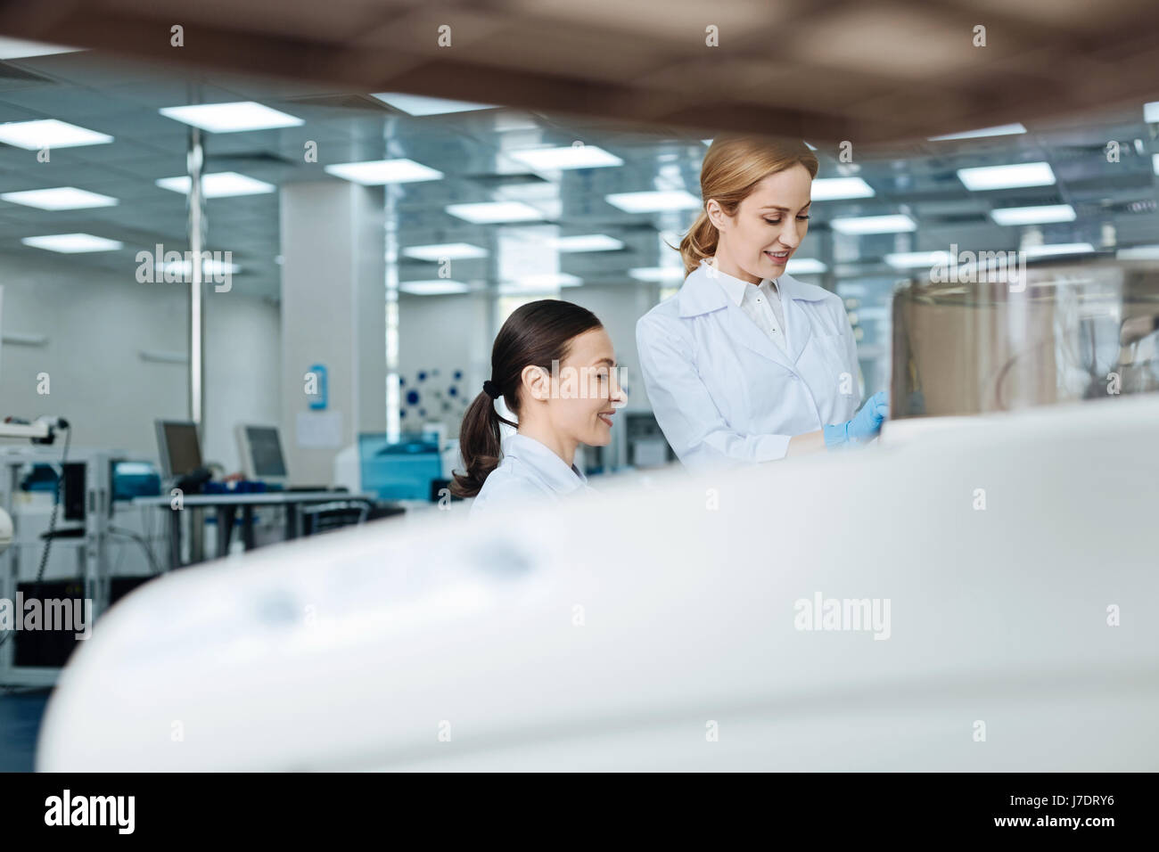 Horizontal photo of positive researchers being in the lab Stock Photo