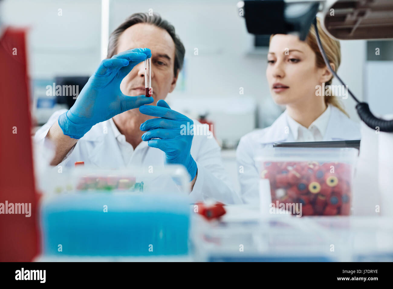 Competent medical worker demonstrating necessary test glass Stock Photo