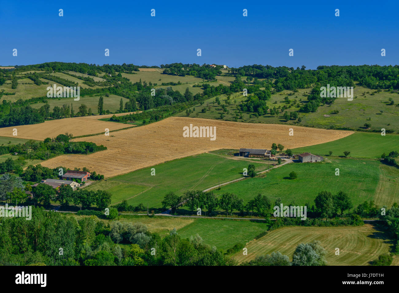 Elevated view of summer fields near harvest time, in the medieval village of Cordes-sur-Ciel. The Occitanie region of Southern France. Stock Photo