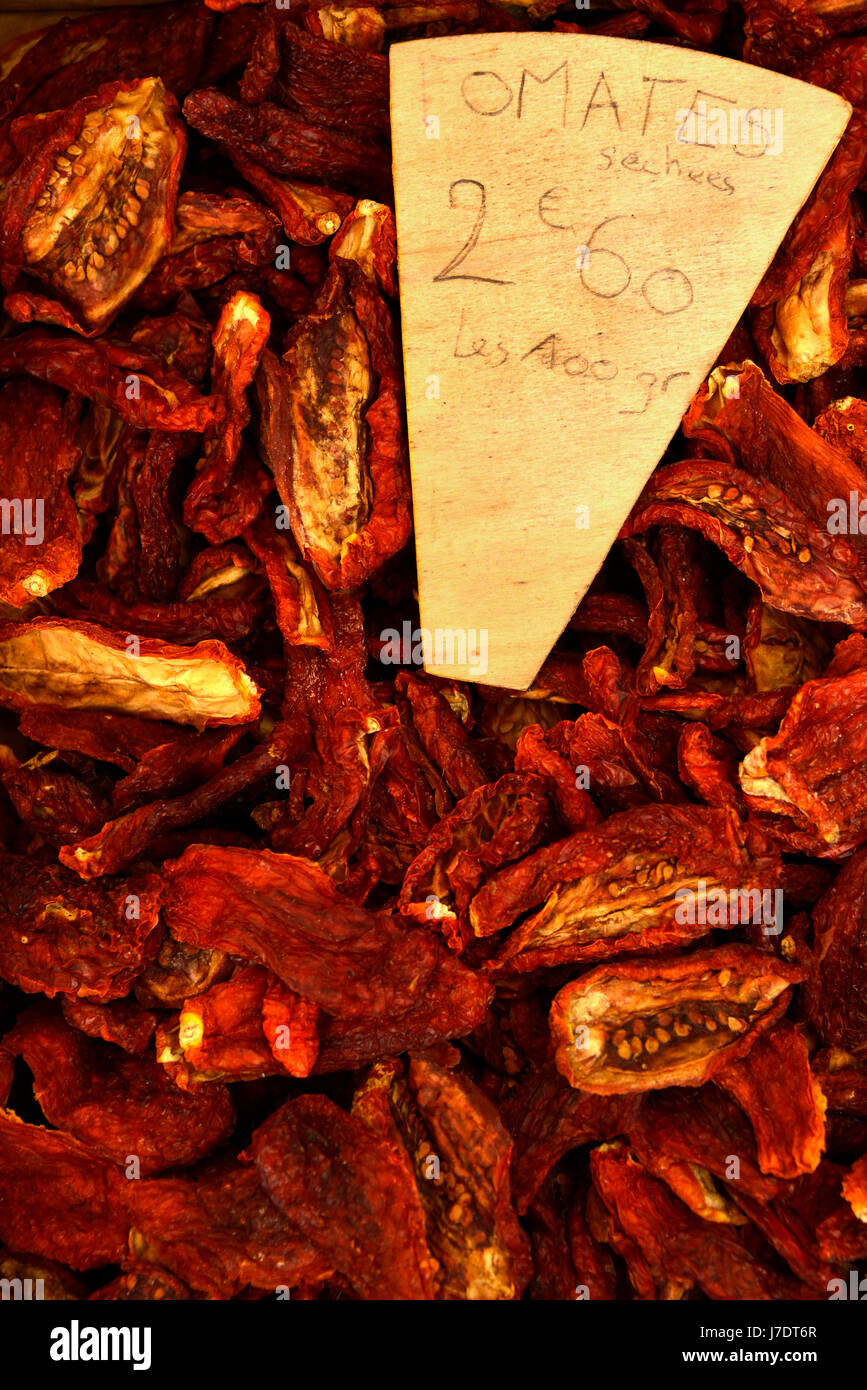 Close up views of French market produce at St Antonin Noble Val. Sun dried tomatoes, with a price tag in Euros. Stock Photo