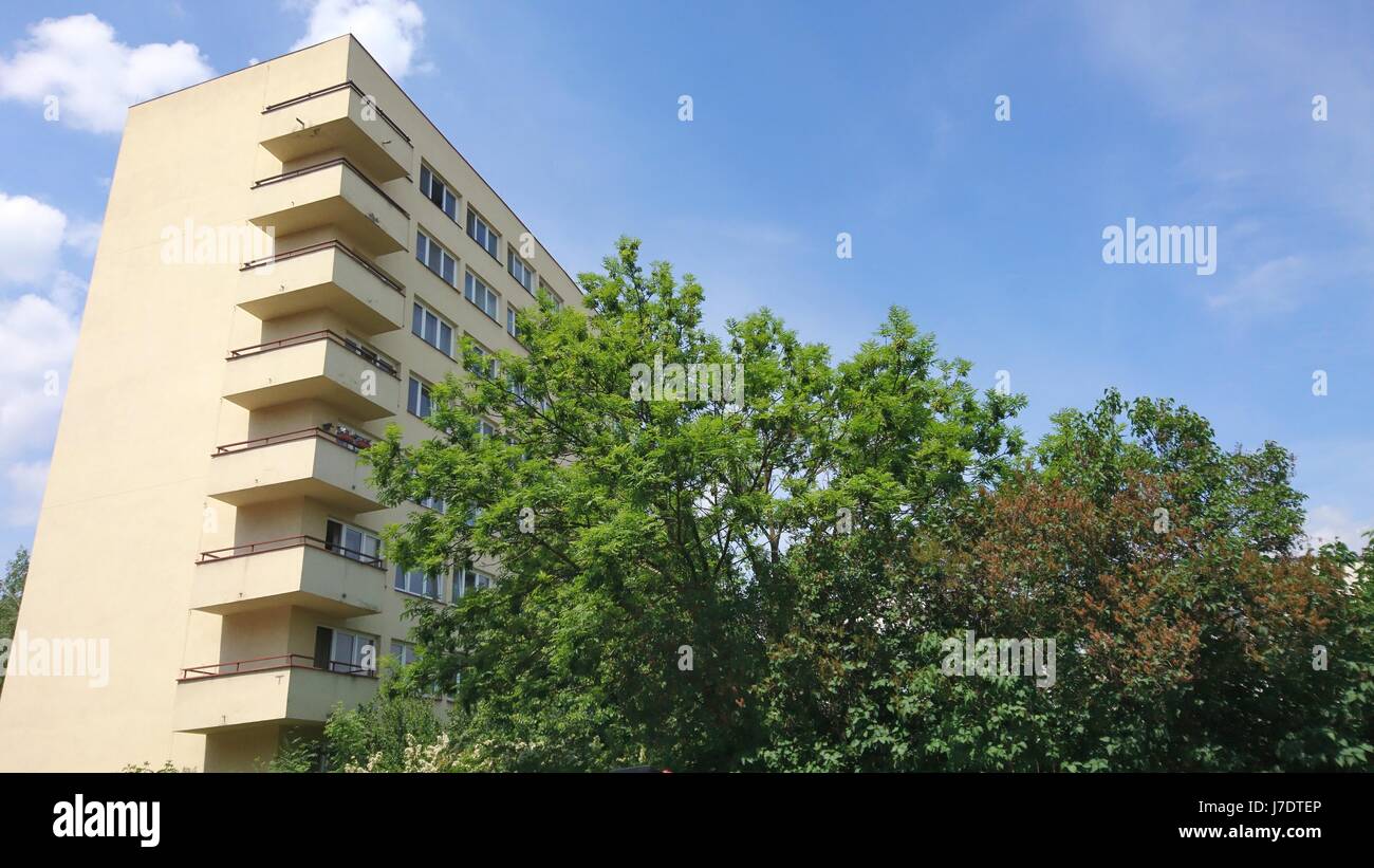 Low anglw view of apartment building exterior hidden behind the big