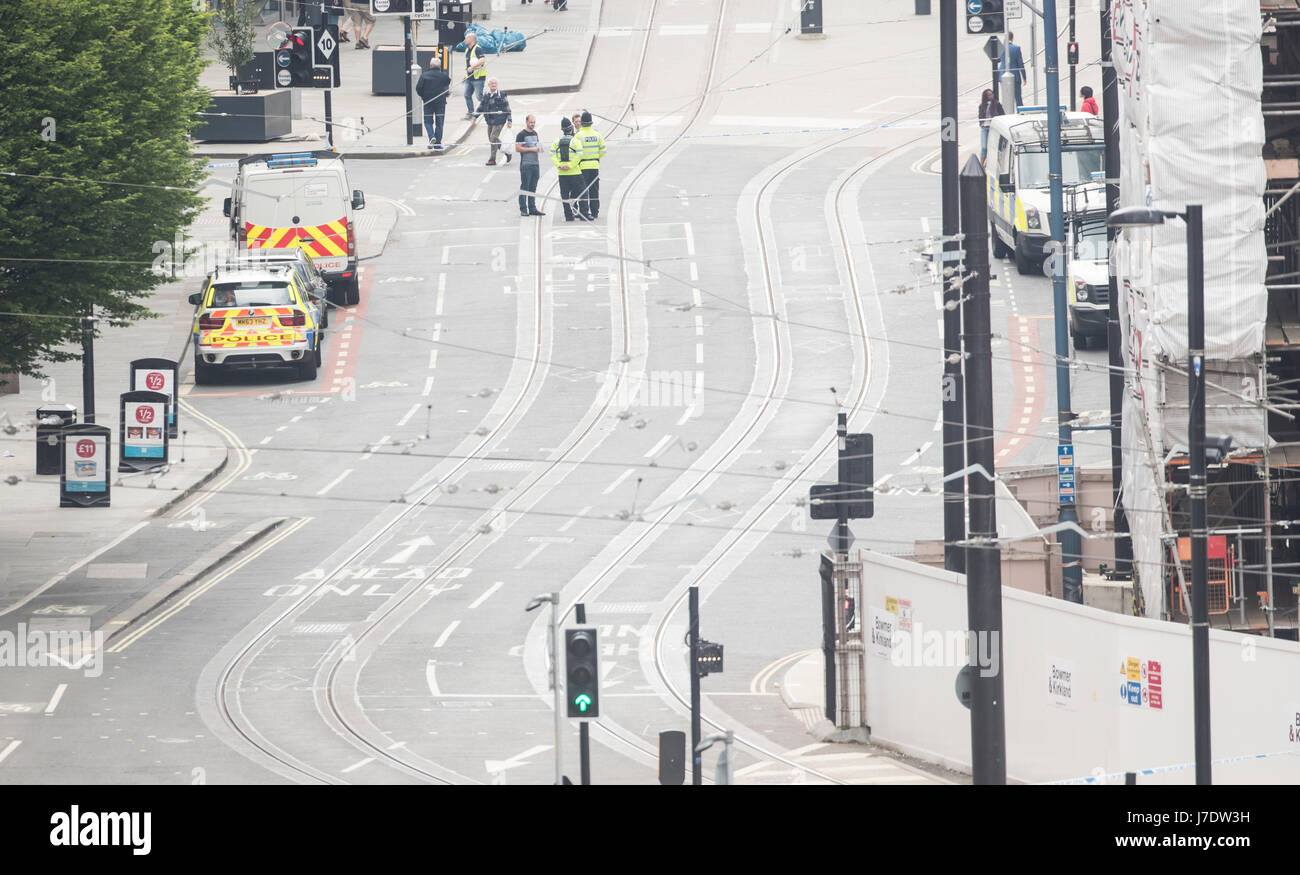 Police officers stand in a closed-off Corporation Street near the Manchester Arena after a suicide bomber killed 22 people leaving a pop concert at the venue on Monday night. Stock Photo