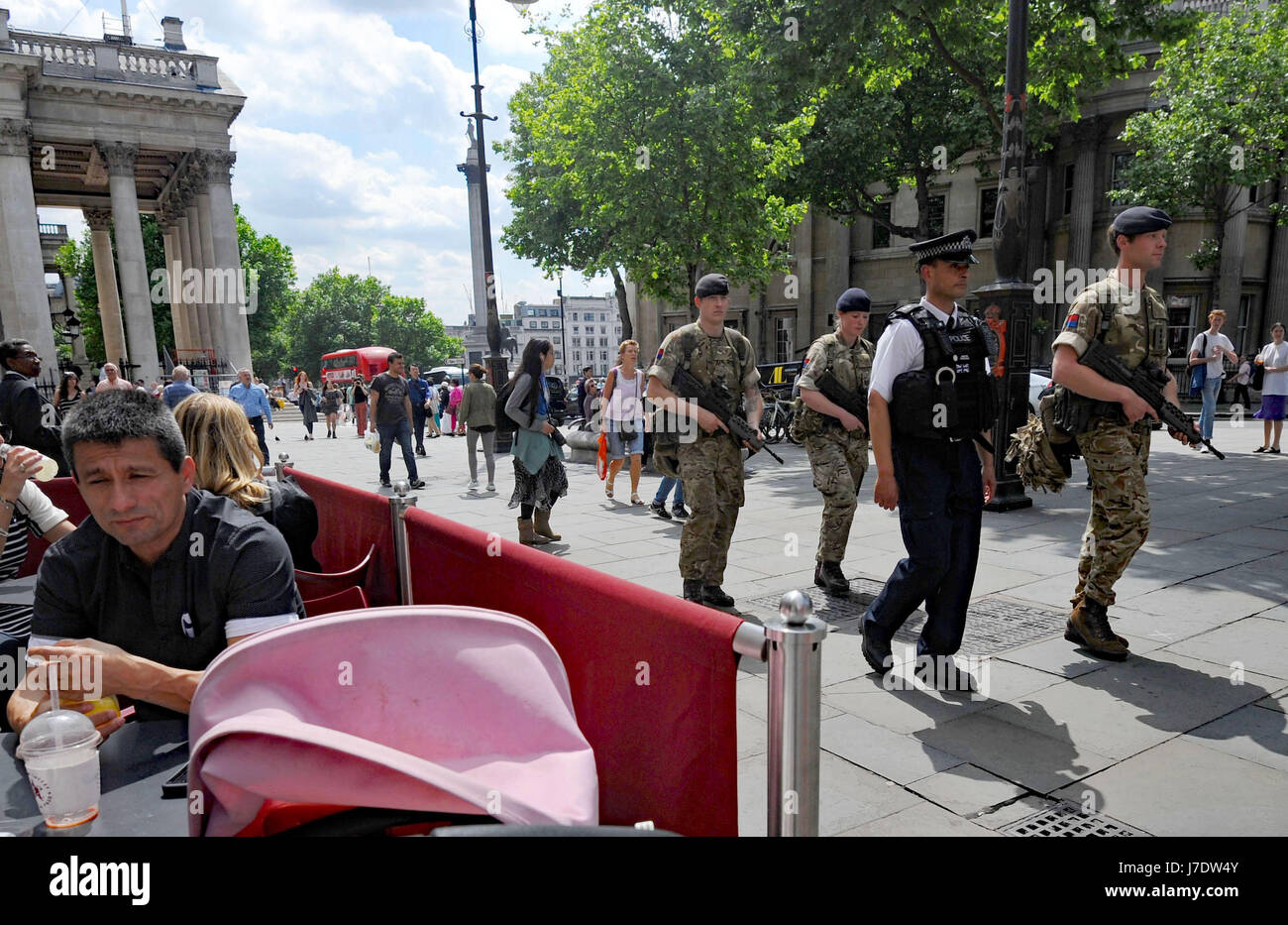 Members of the army join police officers on Whitehall, London, after Scotland Yard announced armed troops will be deployed to guard "key locations" such as Buckingham Palace, Downing Street, the Palace of Westminster and embassies. Stock Photo