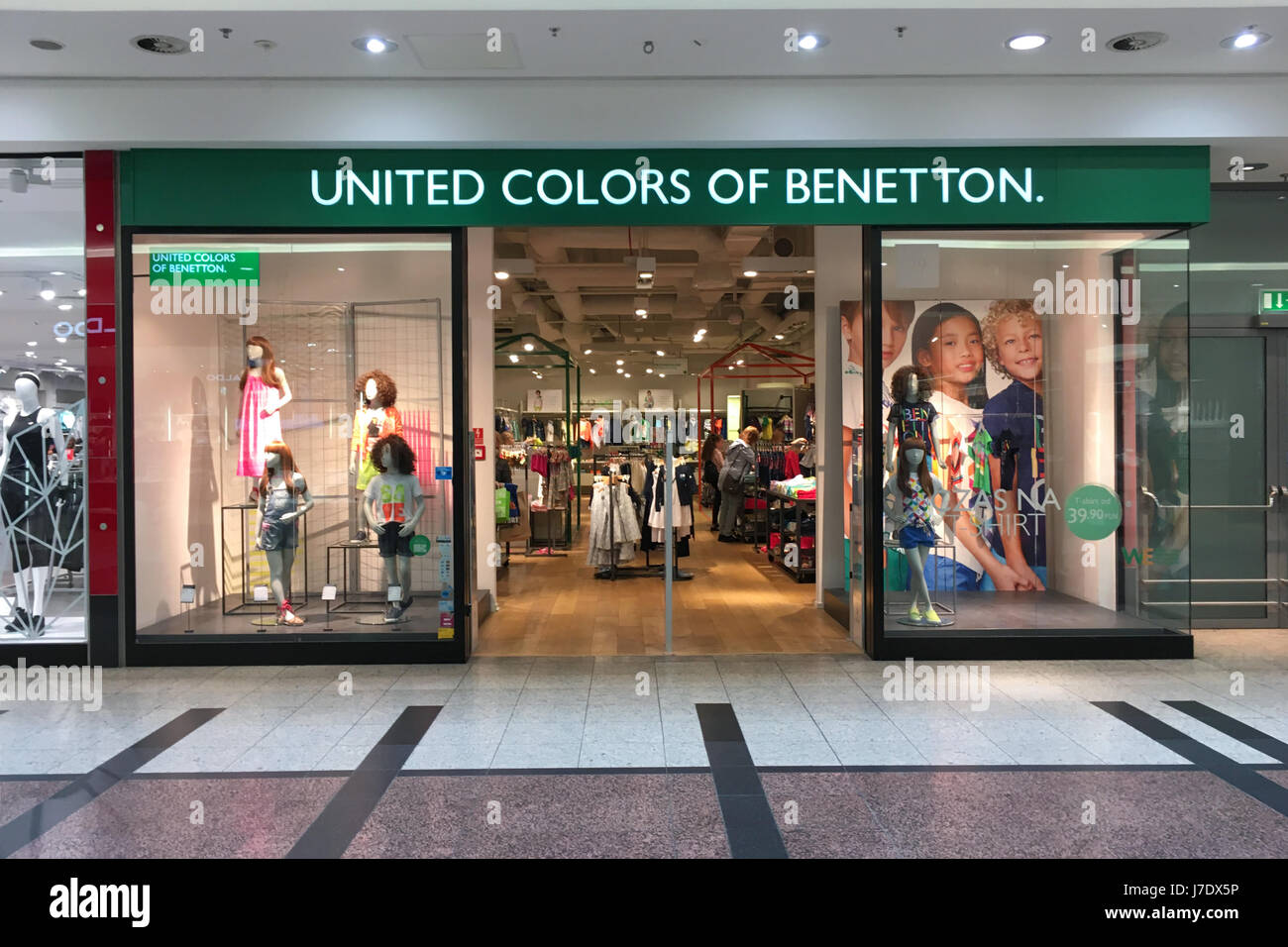 United Colors of Benetton retail clothing store, shop entrance with people,  people on street sidewalk, windows and clothes on display Stock Photo -  Alamy