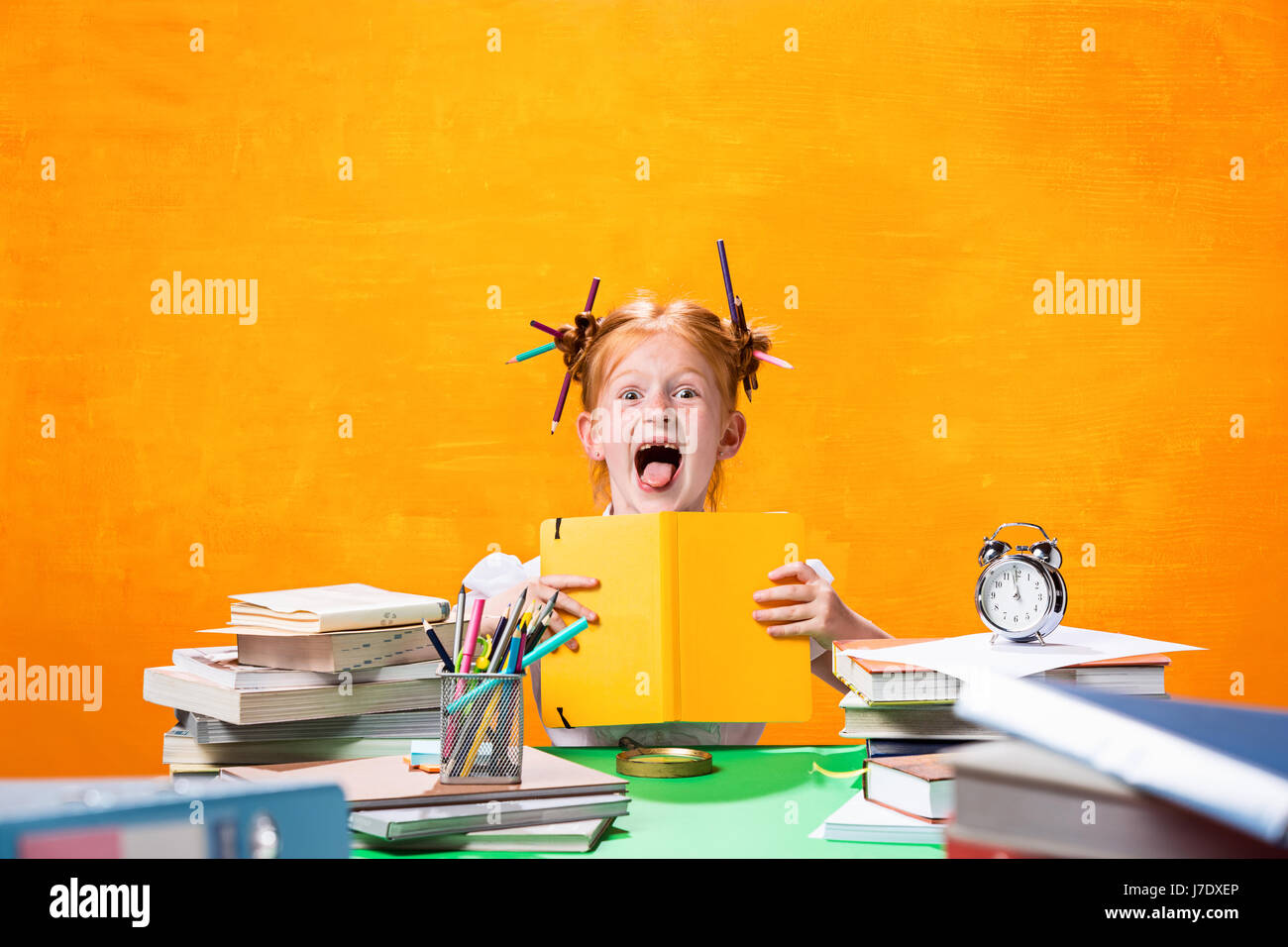 The Redhead teen girl with lot of books at home. Studio shot Stock ...
