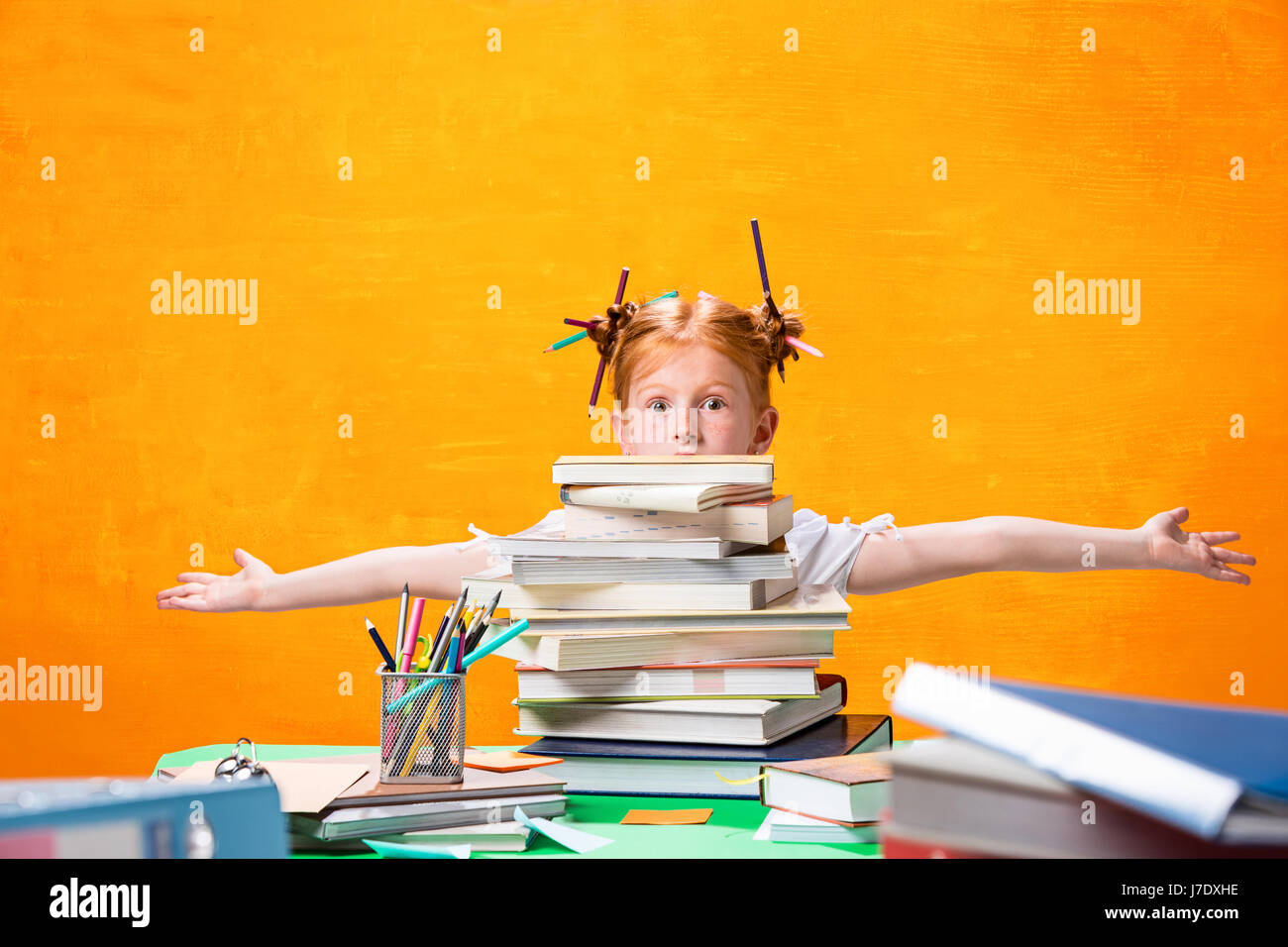 The Redhead teen girl with lot of books at home. Studio shot Stock ...