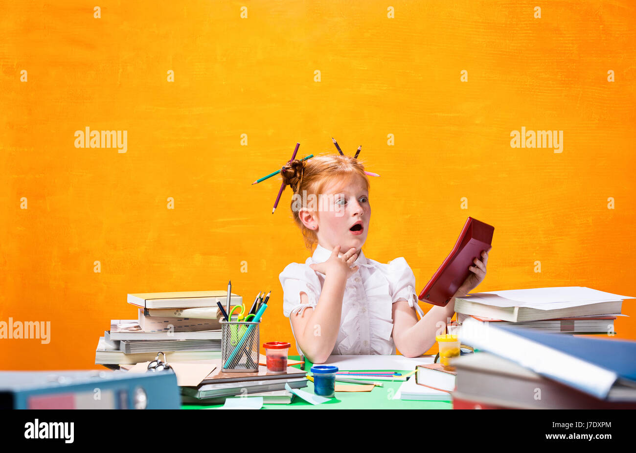 The Redhead teen girl with lot of books at home. Studio shot Stock ...