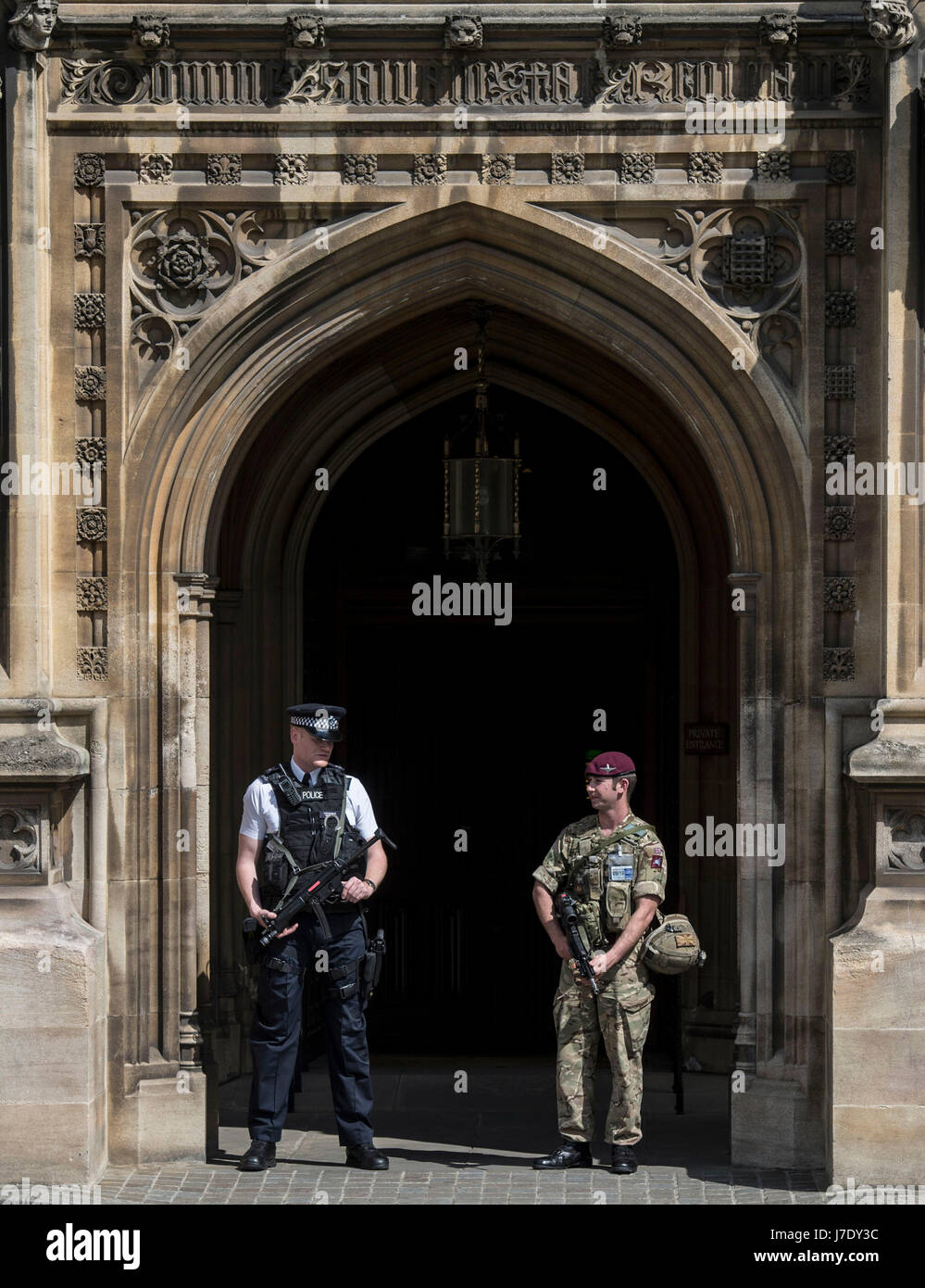 Members of the army join police officers in Westminster, London, after Scotland Yard announced armed troops will be deployed to guard "key locations" such as Buckingham Palace, Downing Street, the Palace of Westminster and embassies. Stock Photo