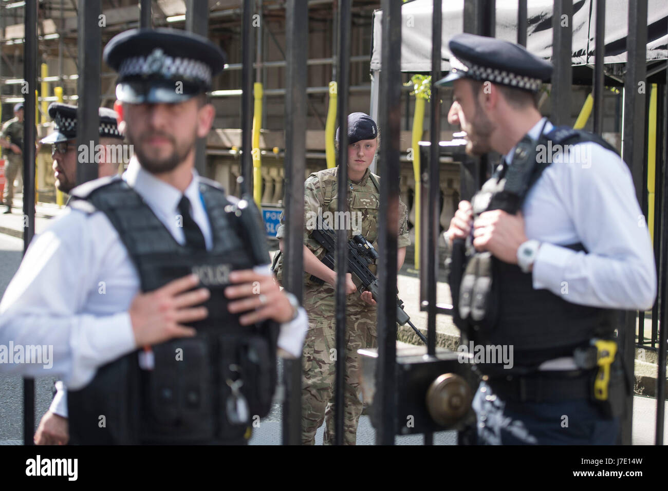 Soldiers join police officers at Downing Street in Westminster, London, as armed troops have been deployed to guard 'key locations' under Operation Temperer, which is being enacted after security experts warned the Government that another terrorist attack could be imminent. Stock Photo