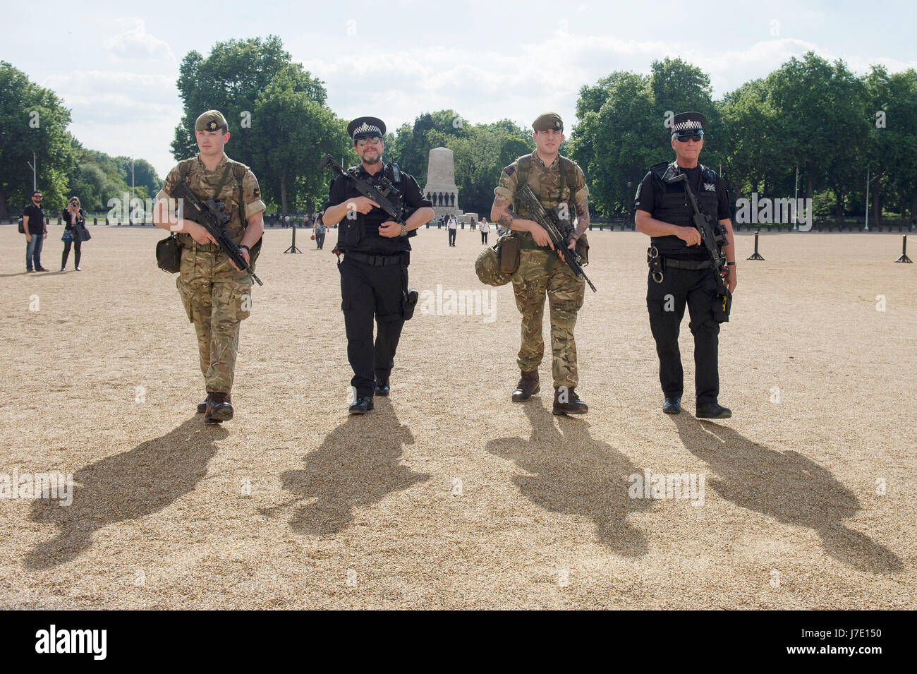 Soldiers join police officers on Horse Guards Parade in Westminster, London, as armed troops have been deployed to guard 'key locations' under Operation Temperer, which is being enacted after security experts warned the Government that another terrorist attack could be imminent. Stock Photo