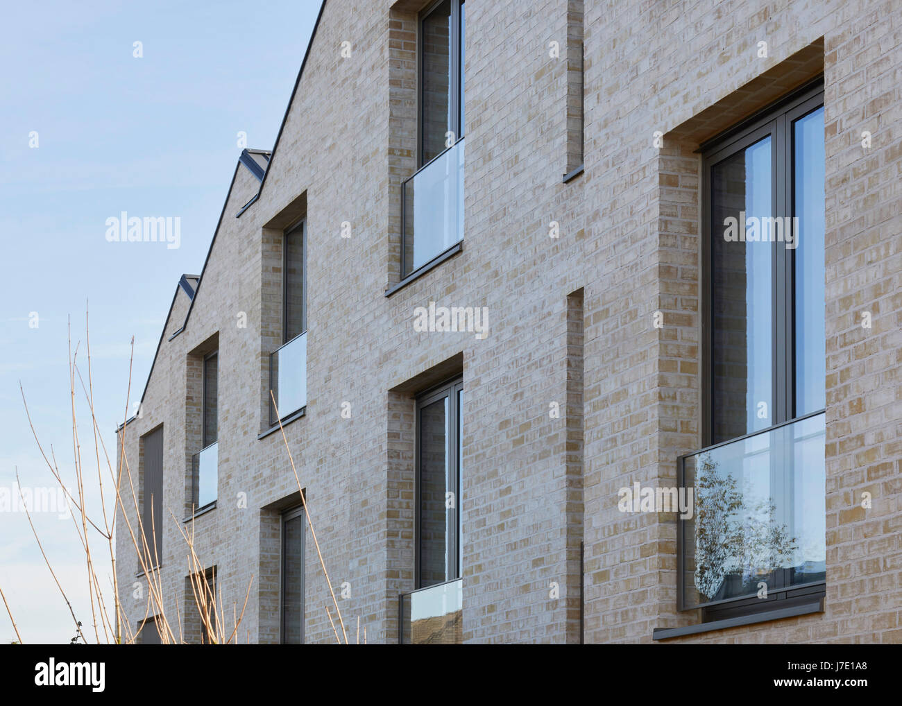 Brick facade detail with windows and gabled roof. Paradise Gardens, London, United Kingdom. Architect: Lifschutz Davidson Sandilands, 2016. Stock Photo