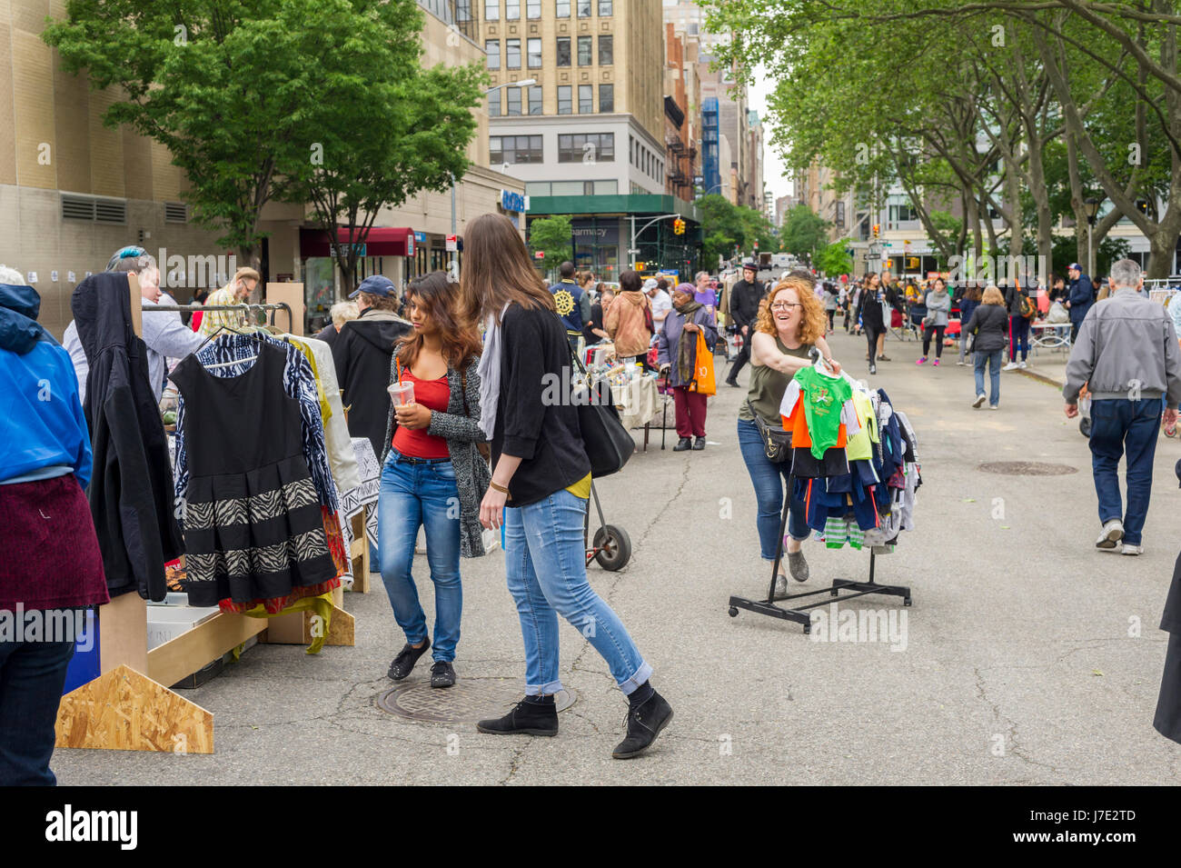 Shoppers search for bargains at the humongous Penn South Flea Market in the New York neighborhood of Chelsea on Saturday, May 20, 2017. The flea market appears like Brigadoon, only once every year, and the residents of the 20 building Penn South cooperatives have a closet cleaning extravaganza. Shoppers from around the city come to the flea market which attracts thousands passing through.  (© Richard B. Levine) Stock Photo