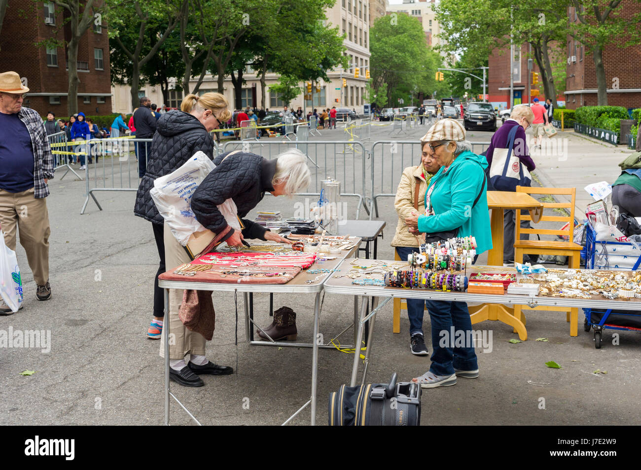 Shoppers search for bargains at the humongous Penn South Flea Market in the New York neighborhood of Chelsea on Saturday, May 20, 2017. The flea market appears like Brigadoon, only once every year, and the residents of the 20 building Penn South cooperatives have a closet cleaning extravaganza. Shoppers from around the city come to the flea market which attracts thousands passing through.  (© Richard B. Levine) Stock Photo