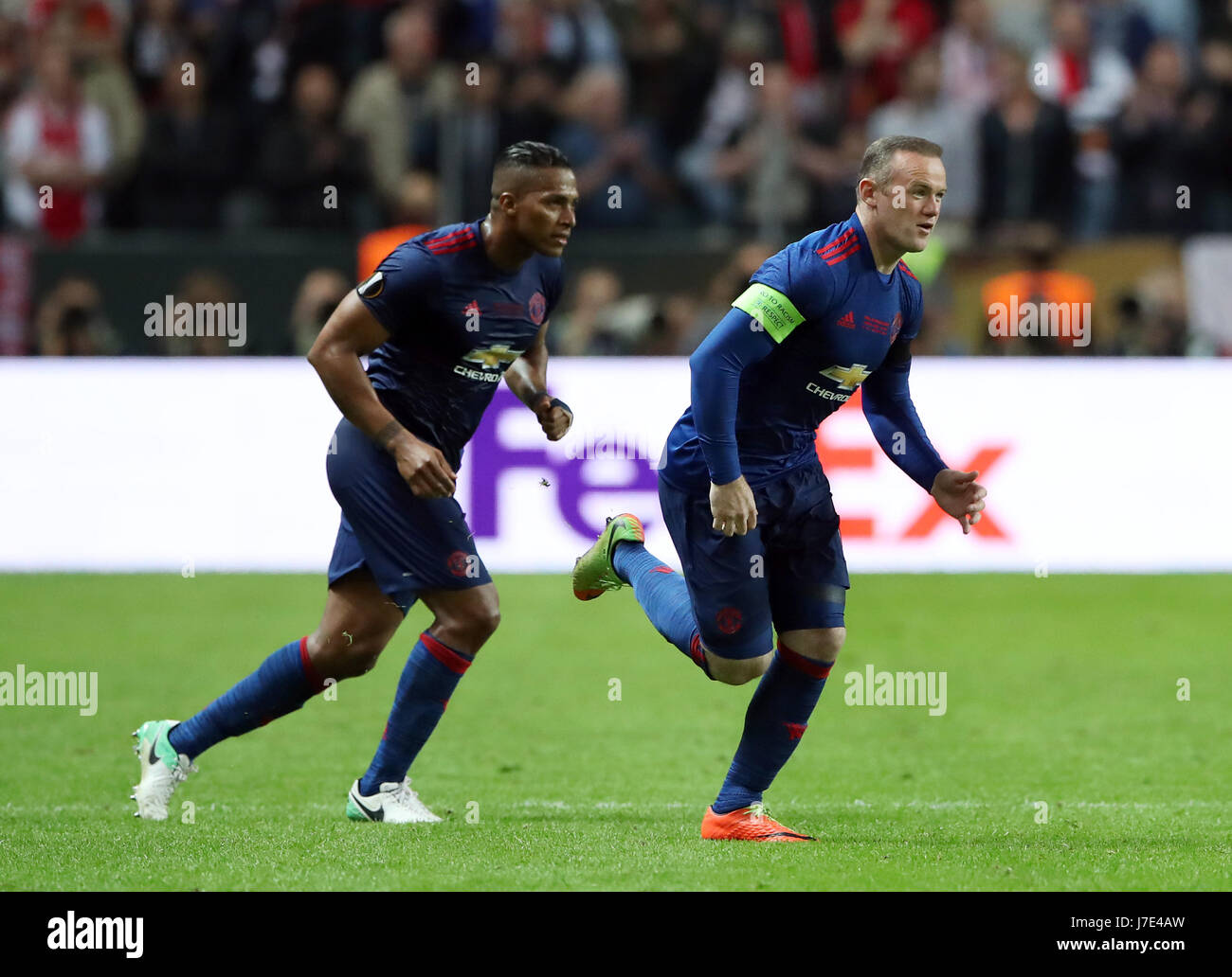 Manchester United's Luis Antonio Valencia (left) gives the captain's armband to Wayne Rooney as he is substituted on during the UEFA Europa League Final at the Friends Arena in Stockholm, Sweden. Stock Photo