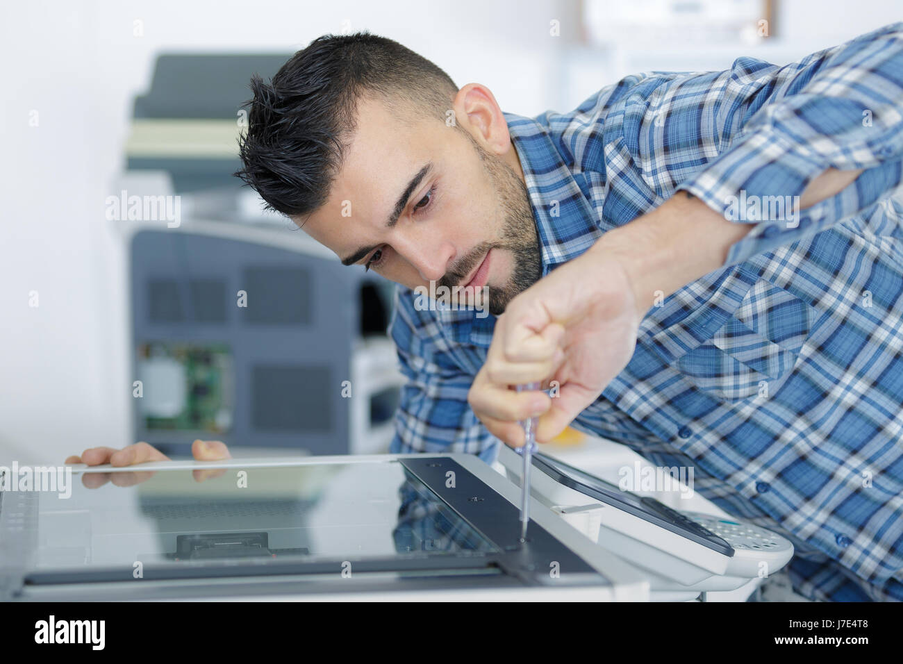 Fixing Copy Machine man fixing photocopying machine Stock Photo - Alamy