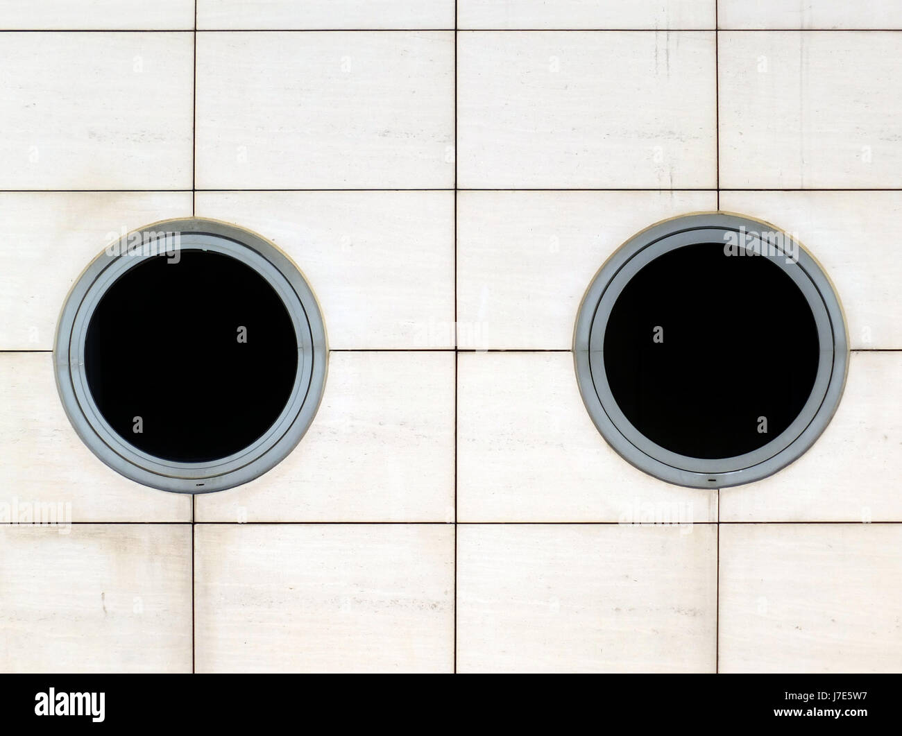 two round windows in a white wall - modern architecture Stock Photo - Alamy