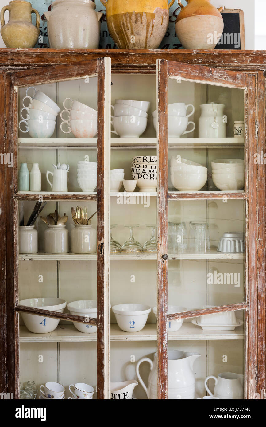 Large confit pots on top of a rustic display cabinet from Hill & Co Home Stock Photo