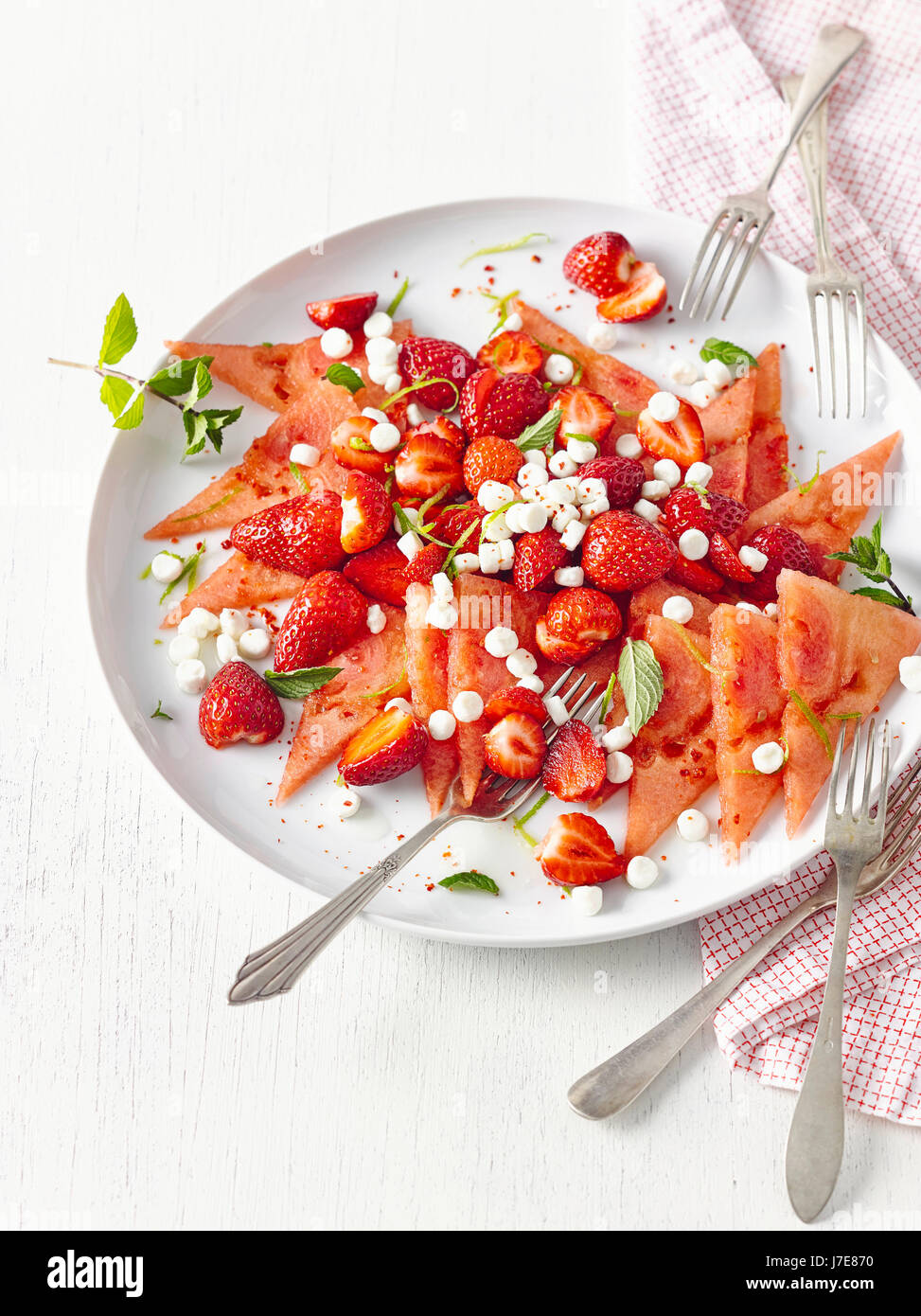 Melon carpaccio with strawberries and goat cheese Stock Photo