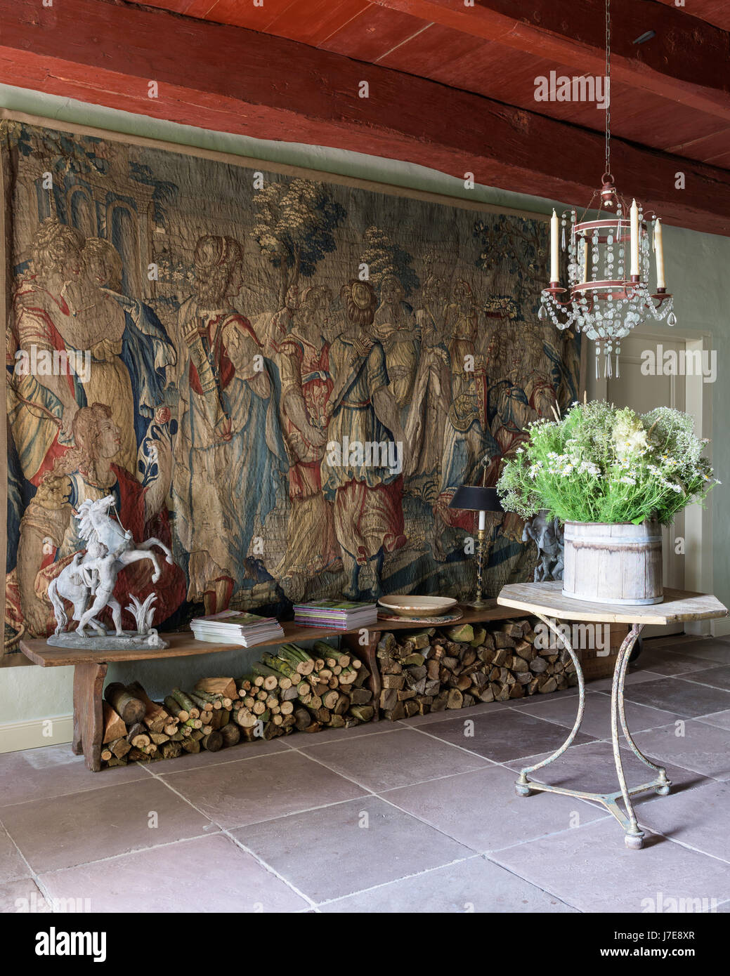 17th century Flemish tapestry 'Triumph of Diana' with cafe table and French mid-19th century glass chandelier Stock Photo