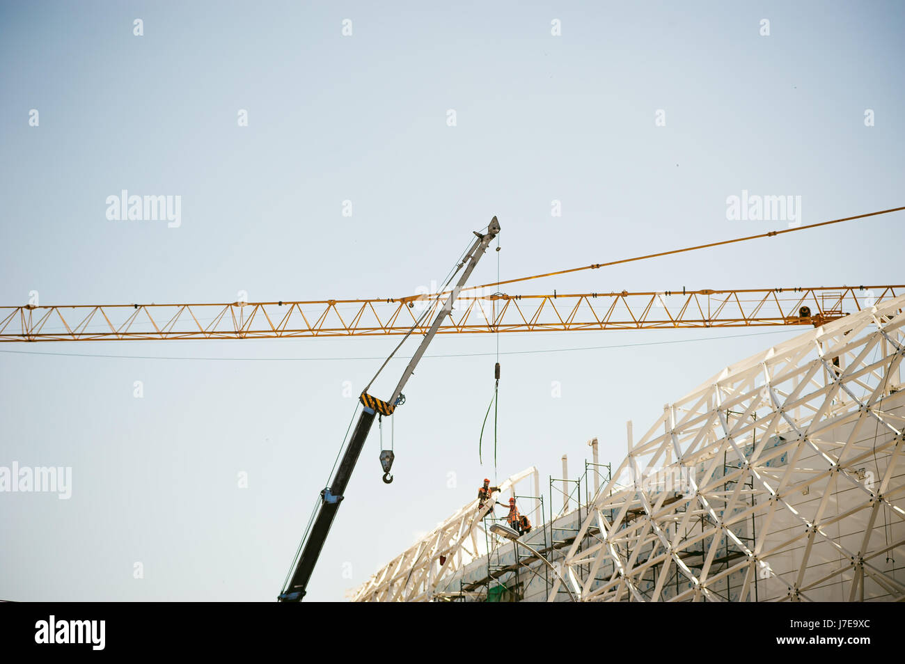 Overall Build man in overalls builder fixes on the height. Assembling, refurbishment ...
