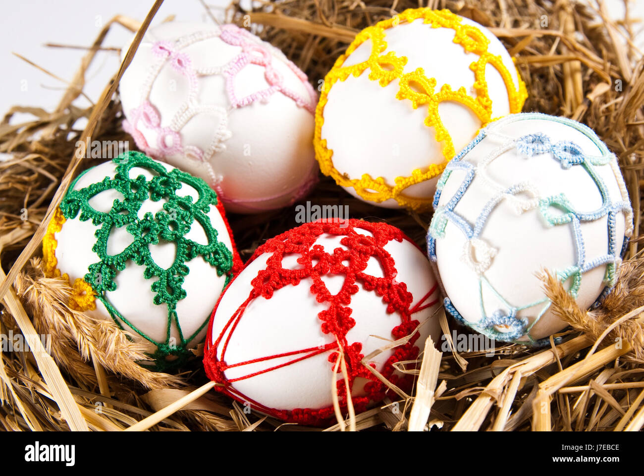easter eggs in straw nest Stock Photo - Alamy
