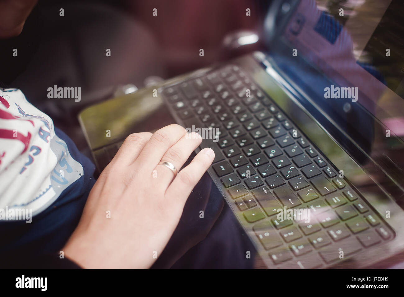 Professional man with a laptop in car tunes tuning control system ...