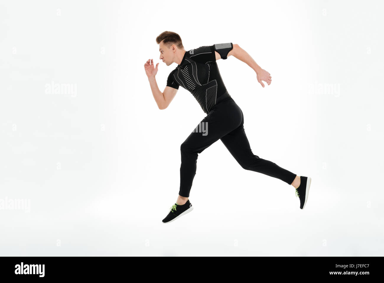 Side view full length portrait of a concentrated young sportsman ...