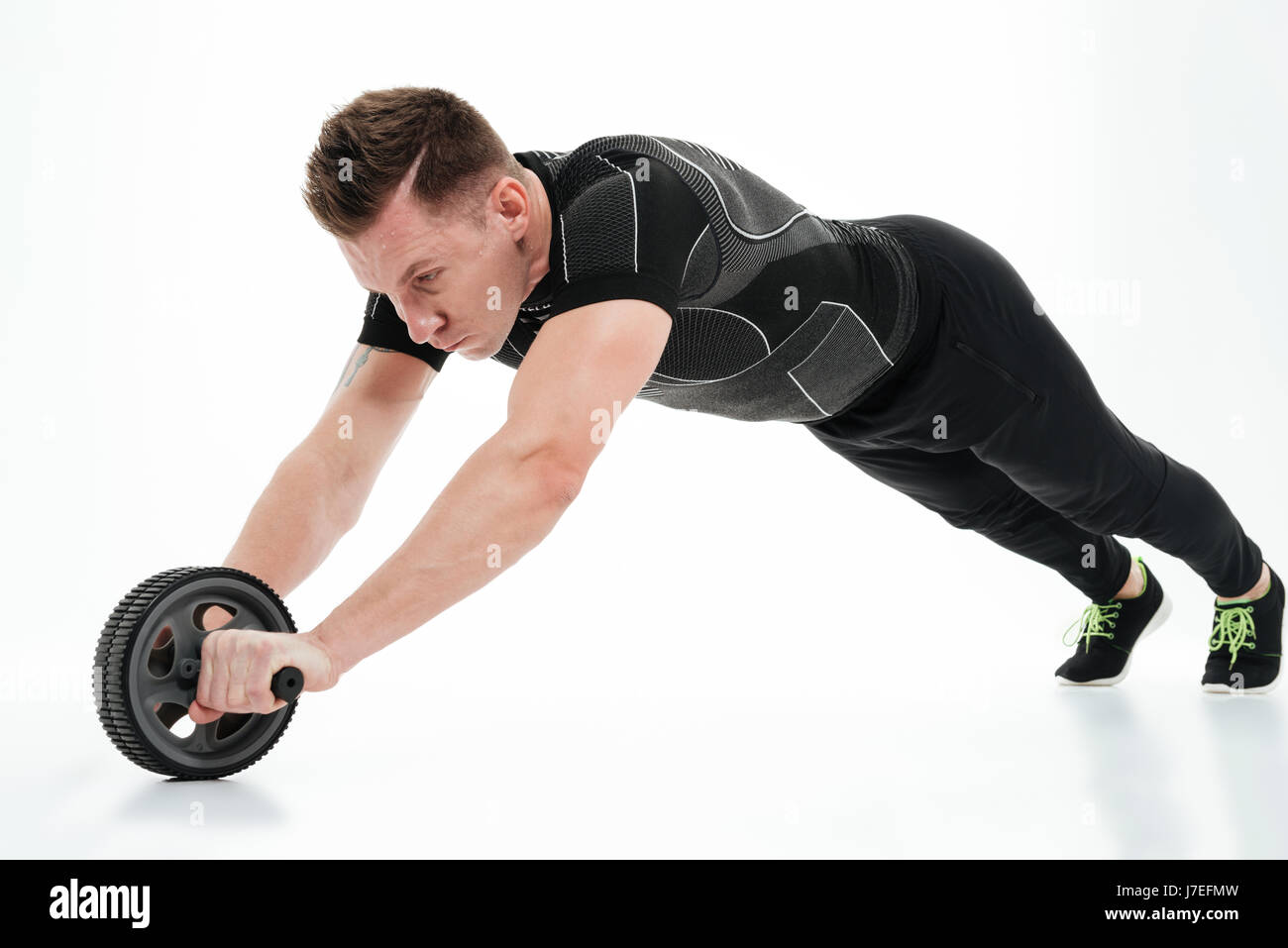 Full length portrait of a muscular healthy athlete man doing exercises