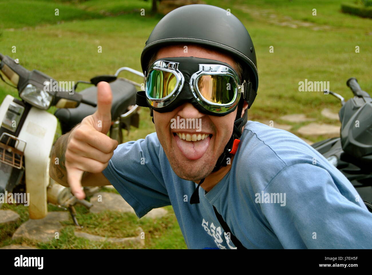 Australian traveler wearing goggles and a helmet, Da Lat, Vietnam Stock Photo