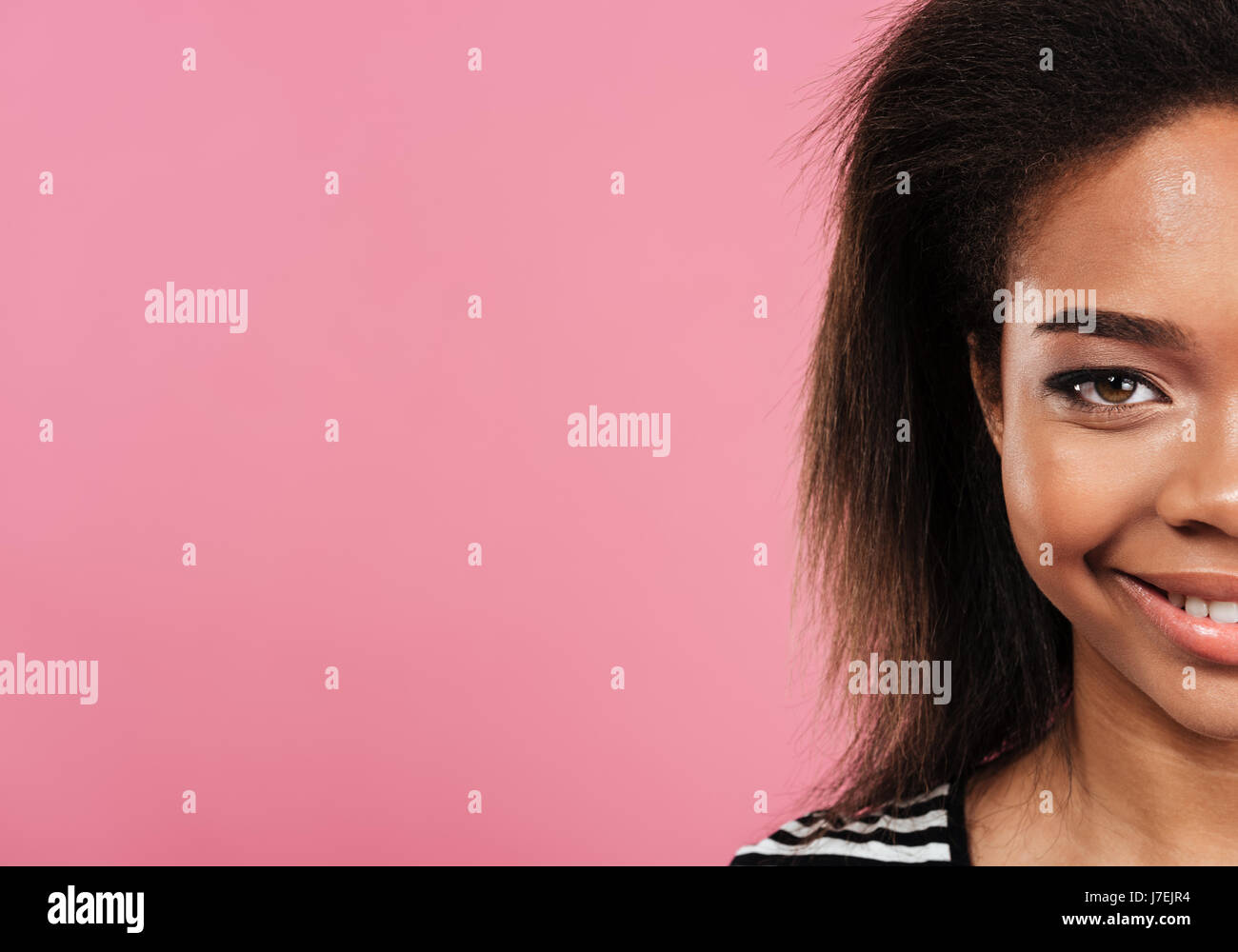 Cropped image close up of half smiling african woman face looking at ...