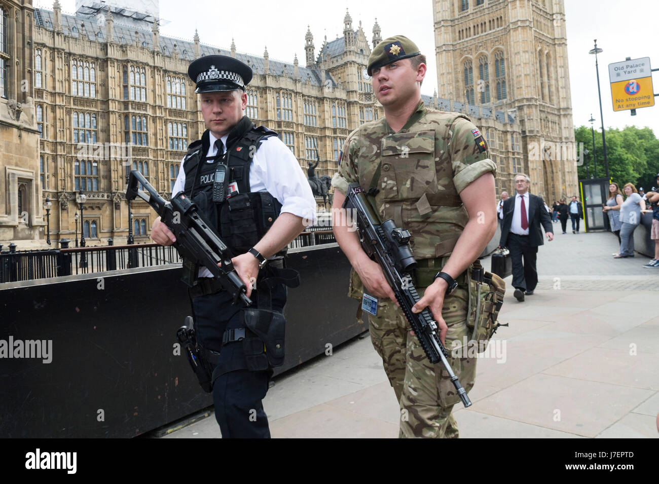 Armed police patrol outside the houses of parliament in london hi-res ...