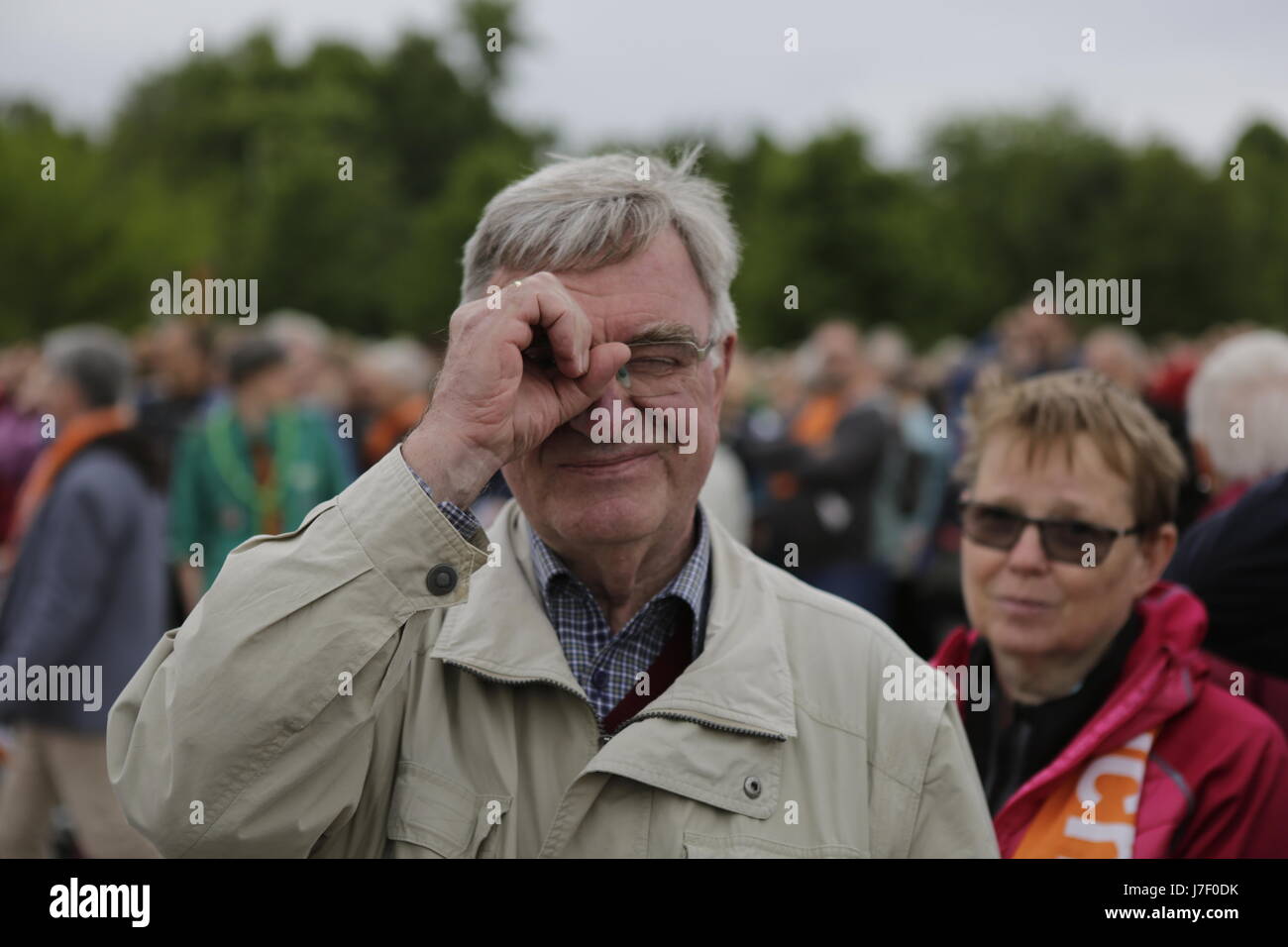 A pilgrim make the gesture of watching something with a telescope, which hints at the slogan of the Kirchentag 'You see me' and is intended to be used as flashmob during the congress. Tens of thousands of people attended the opening services of the 36th German Protestant Church Congress (Evangelischer Kirchentag). The Congress is held from 24. to 28. May in Berlin and more than 100,000 visitors are expected to attend. The congress coincides with the 500. anniversary of the Reformation. Photo: Cronos/Michael Debets Stock Photo